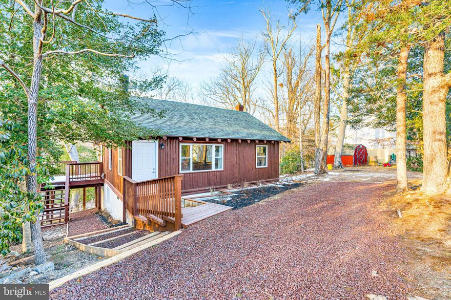 Looking for a great home on a nice lot??? This home was recently renovated and updated and offers so much for a new owner or an investor who would like to continue to use as an airbnb or long term rental. This house is rustic and cool with tall ceilings and a loft area currently set up with extra sleeping arrangements for the airbnb.  The kitchen is updated and finished with modern finished, quartz counters and newer appliances and cabinets. The bathrooms are fresh and newer but bring in the cabin feel with the tile and finishes. Enjoy the lovely back enclosed porch offering a wall of windows peering over the private lot and take a nap. Head to the basement for the finished area with a walk out basement and an additional room currently used as a bedroom/laundry room with a full bathroom.  Do not let this one slip on by it is a cool unique cabin with cool vibes and newer touches. Don't forget this house qualifies for 100% financing with the USDA program and Maryland Mortgage Program for down payment assistance and closing help.