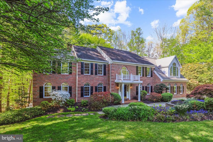 Welcome to this sun-drenched, brick-front colonial with a three-car side-load garage, nestled on a beautifully landscaped 0.77-acre premium lot with serene woods, a gentle creek and backs to Fairfax Station HOA common area.

A charming front portico leads into an elegant two-story foyer, highlighted by a grand circular staircase. The spacious formal living room flows into a stunning 17x16 conservatory with custom cabinetry and three walls of tall Palladian windows offering peaceful wooded views. The formal dining room is perfect for entertaining and is conveniently located next to a butler’s pantry with cabinetry, wet bar, double coat closet, and access to the garage.

The heart of the home is a spectacularly remodeled 24’x15’ gourmet kitchen featuring custom cabinetry, marble countertops, stainless steel appliances, a large island with cooktop, and a walk-in pantry. The adjoining sunroom/breakfast area opens to an expansive 995 sq ft deck overlooking the backyard retreat. A cozy family room with a brick gas fireplace, wood mantel, accent lighting, and French doors to the deck offers the perfect place to unwind.

Upstairs, the luxurious 29’x21’ primary suite is a true sanctuary with soaring vaulted ceilings, a massive 13.6’x12.75’ walk-in closet, and an opulent spa bath complete with dual vanities, jetted soaking tub, walk-in shower, private water closet and large closet with shelving. The upper level offers three additional bedrooms, including an en-suite with updated bath and walk-in closet, and two more sharing a renovated hall bath. A convenient laundry room with washer/dryer, utility sink, and storage completes the upper level.

Throughout the home, you’ll find elegant details such as hardwood floors, crown molding, wainscoting, new carpet, tall windows, and abundant storage. The unfinished walkout lower level offers 2,100+ sq ft of potential with a rough-in for a full bath, ready to customize exactly how you want it to be.

Recent updates include a remodeled kitchen, refreshed baths, two-zone HVAC, new lighting, fresh paint, and more. Ideally located near shopping, express metro bus service, VRE, and just 30 minutes from IAD and DCA airports, with access to sought-after Fairfax County schools in the Robinson pyramid.

This is a rare opportunity to own an exceptional, well-maintained property—schedule your visit today!
