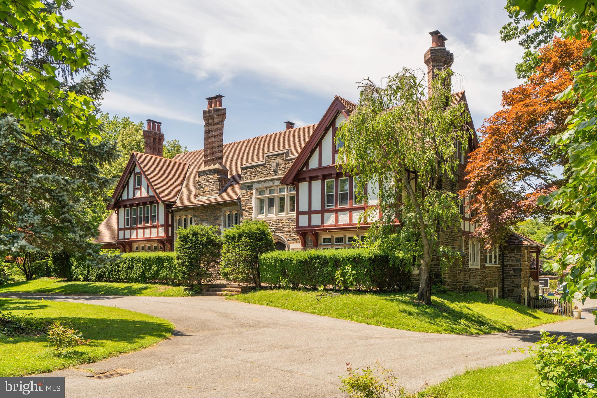 Incredible opportunity to own a piece of Main Line History. This grand Tudor estate built by Albert Barnes offers magnificent architectural detail, gorgeous stone masonry and unsurpassed moulding, woodwork and carvings. This exceptional property offers over 9000' sq. ft. of living space, 8 fireplaces, 13 chimneys, 8+bedrooms, leaded glass windows, a separate carriage home with living quarters and a gorgeous 1.7 acre deep, private lot. The first floor of this home offers enormous rooms including a breathtaking grand hall entry with original red oak flooring, paneling and ceiling beams. Large formal Living Room and Library feature stunning fireplaces and woodwork. Extensive eat-in kitchen with 2 gas ranges, wood cabinetry and quartz countertops. Completing the first floor is a large office with wonderful views of the sprawling backyard. The 2nd and 3rd floors of this home do not disappoint with 12 rooms several with en suite bathrooms and uses as bedrooms, studios, exercise rooms and offices. The enchanting grounds are private, quiet and picturesque filled with mature plantings and lovely gardens. Truly a remarkable property carefully designed with world class materials and workmanship.