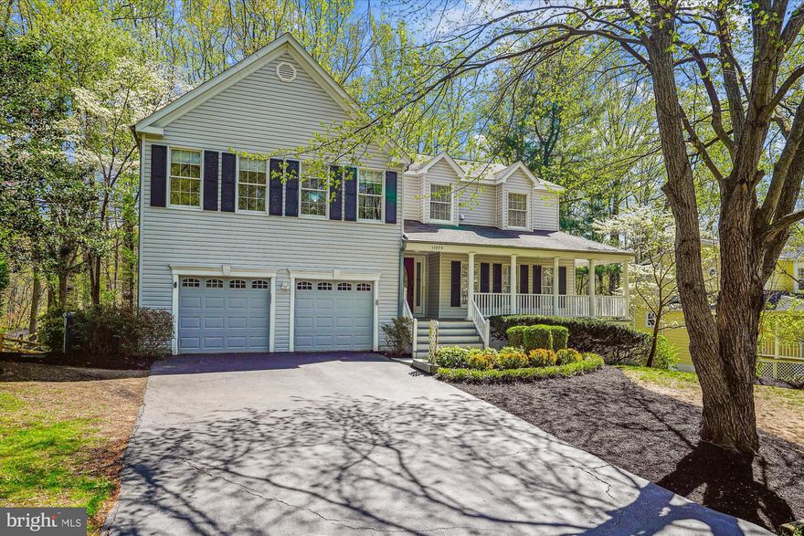 Offer deadline: 2:00 PM, Tuesday, April 15th; Sited on more than a .75-acre wooded lot, this gorgeous 4BR/2.5BA Shaker Woods home offers a private, serene retreat, surrounded stately mature oaks and maple trees. The welcoming entrance, complete with a wrap-around front porch, provides an elegant yet friendly nod to the gracious interior. The main level of this home has been creatively re-imagined with a splendid kitchen remodel. The center island, cooktop, wall ovens and window-centered sink add that special chef’s kiss to this beautiful space. There’s also excellent storage and abundant space for meal prep. The expansive Family Room, with fireplace and access to the rear deck, is truly the heart of this lovely home. The spacious dining room and generous living room can easily and seamlessly accommodate large festive gatherings. Completing the main level is a Powder Room, Pantry and a generously sized two car garage with EV plug-in station.
The second level’s expansive 2-level Primary Bedroom suite features a spacious en-suite bathroom (separate shower stall, jetted tub, dual sinks, water closet), spacious walk-in closet and a sitting room/library. Additionally there are three generously sized Bedrooms, a Hall Bath with dual sinks and tub/shower plus a Laundry Room. Additionally, the entire home has been updated with LVP plank flooring in a pleasing neutral tone and tasteful contemporary lighting compliments the modern/updated aesthetic. 
Of course the private forest-facing rear deck and patio below, are the perfect oasis for that morning cup of coffee, candle-lit al fresco dinners or autumn hot chocolate gatherings around a fire pit. The natural beauty of this location is unmatched. The convenient Shaker Woods community provides easy access to local amenities including proximity to Reston Town Center and Northpoint Center. Restaurants (Call Your Mother, Gregorio’s Trattoria, Finn Thai) and  Giant grocery are so close. The Reston Association pools are available in the summer, along with neighborhood walking trails and nearby parks. Also with Rt. 7 close-by and and Rt. 267, it's a commuter’s dream. Shouldn’t 11575 Southington Lane be your new home address?