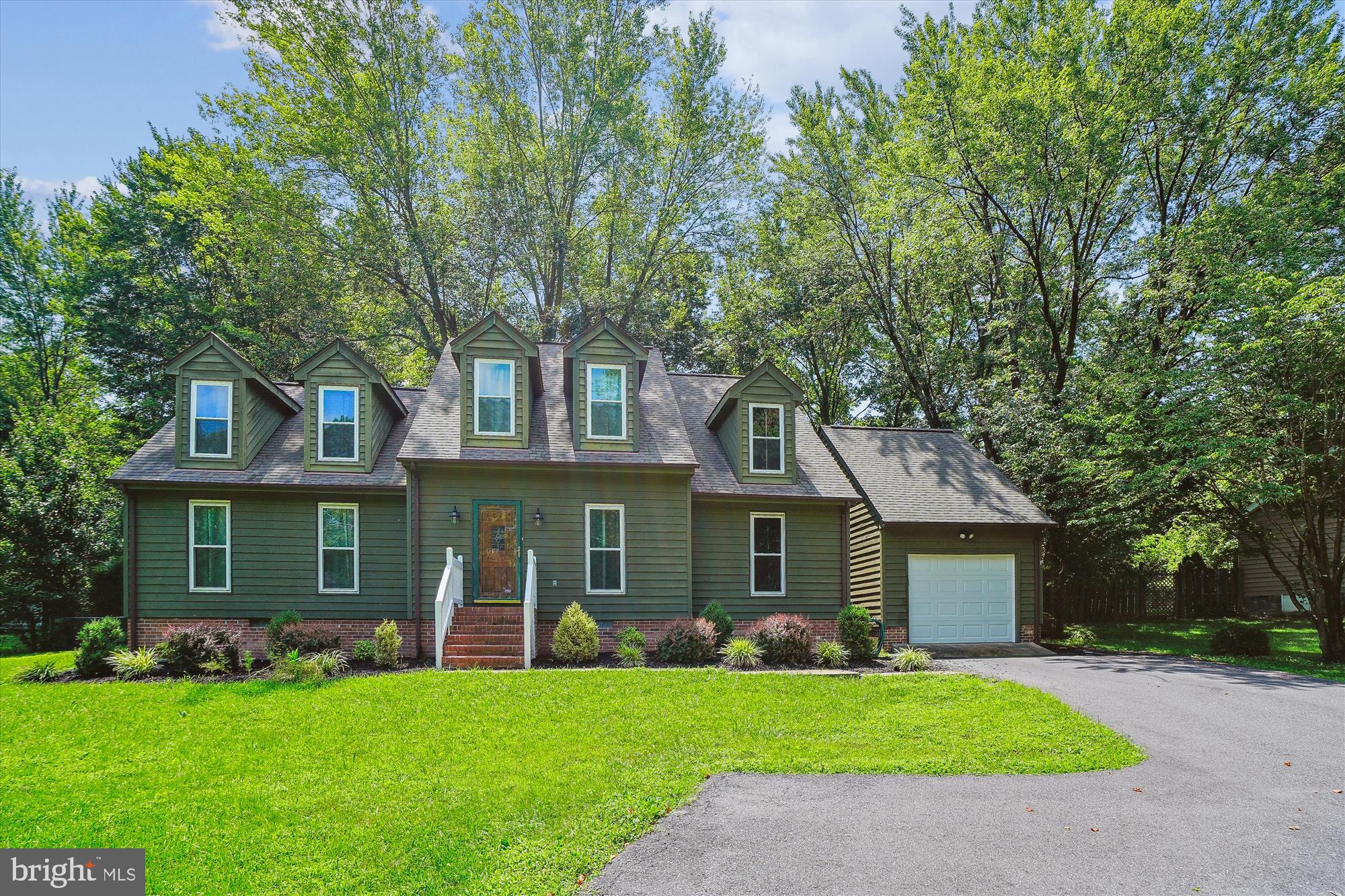 This stunning home offers a bright and inviting layout, enhanced by skylights throughout that fill the space with natural light. The main level features a gourmet kitchen with stainless steel appliances, a center island, and ample cabinet storage. A separate eat-in area sits beneath sun-filled skylight windows, creating the perfect spot for morning coffee or casual dining. Enjoy the grand two-story family room with a charming brick-front fireplace. A dedicated office with elegant glass French doors provides a quiet workspace, and a convenient powder room completes the main level. Upstairs, you'll find four spacious bedrooms, including a primary suite with an ensuite bath and dual vanity. One of the guest bedrooms features a unique walk-in closet with generous storage space, offering added functionality. Guest bedrooms share a full hallway bathroom. Additional highlights include a newly built back deck, a fully fenced backyard for privacy, and a detached one-car garage with generous storage space. Laundry is included for added convenience.