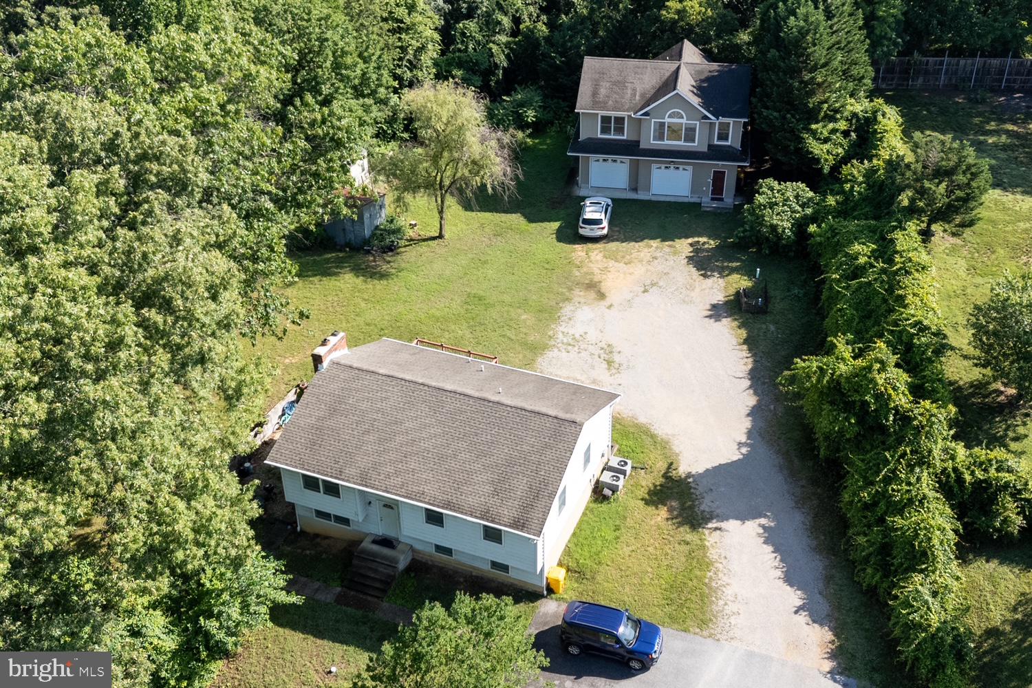 LARGE, PRIVATE LOT SURROUNDED BY MATURE TREES ON 3 SIDES, YET VERY CONVENIENT ACCESS TO EVERYTHING**MAIN SPLIT FOYER HOME BEING USED AS TWO SEPARATE LIVING SPACES**UPSTAIRS HAS 3 BEDROOMS, 2 FULL BATHROOMS, BEAUTIFUL HARDWOOD FLOORS, & DECK OFF THE KITCHEN FOR EASY BARBEQUES**LOWER LEVEL HAS 2 MORE BEDROOMS, ANOTHER FULL BATH, LAUNDRY, AND KITCHEN W/ WALK-OUT LEVEL PATIO**HUGE DETACHED TWO-CAR GARAGE ADDS A HALF BATH ON THE ENTRY LEVEL AND THIRD SPACE ABOVE WITH 2 BEDROOMS, FULL BATH, KITCHEN, PRIVATE DECK, ETC.**QUICK ACCESS TO MAJOR HIGHWAYS FOR EASY COMMUTE TO NEARBY FORT MEADE/NSA, ANNAPOLIS, BALTIMORE, AND DC**NEARBY SHOPPING, RESTAURANTS, & RECREATION**DON'T MISS THIS UNIQUE OPPORTUNITY**SEE IT TODAY!!