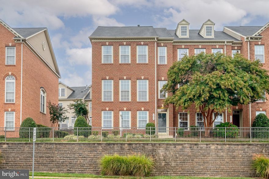 This NV Homes Astor model is a luxury end of group townhome in Honeygo Village offering stylish living space in one of Perry Hall’s most sought-after walkable communities. Step inside through the front door or your oversized two-car garage (new garage door motor) and find a flexible entry-level space—perfect as a 4th bedroom, playroom or home office—with new luxury vinyl plank flooring and private full bath access. It's steps away from the laundry. The main level showcases a bright and open floor plan with floor-to-ceiling windows, hardwood floors, and custom molding. The spacious living room flows into the dining area, while the gourmet kitchen boasts granite countertops, new faucet and reverse osmosis water filtration system, stainless steel appliances, a center island and breakfast nook. Step outside to your low-maintenance deck, ideal for outdoor dining and relaxation. Upstairs, retreat to the luxurious primary suite with vaulted ceiling, walk-in closet with custom organization system and an attached spa-like bath. Two additional bedrooms and a full hall bath complete the upper level. Other upgrades include new water heater, oak stairs, new carpet upstairs, hardwood floors throughout the main level and two newer storm doors. With exterior maintenance handled by the association, you’ll enjoy a truly carefree lifestyle with no yardwork required. All this plus an unbeatable location—just steps to restaurants, bars, shopping, and minutes to local parks and I-95 for easy commuting.