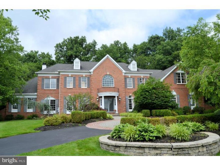 By far and away the most spectacular property ever offered in Meadow Wood at River Crossing. Sited perfectly on a lush 3.62 acre parcel, this exquisite and spacious brick front estate home is replete with high end custom finishes and features throughout. Each room features a perfect blend of color, materials and light. The property, with impressive circular driveway, features 4/5 bedrooms, 5.5 baths, incredible in ground pool, finished lower level and over 6,300 finished square feet. The soaring two foyer entry welcomes you with sparkling marble floors, double turned hardwood staircase. To the right is the elegant formal dining room with silk covered padded walls, and butlers pantry with wine cooler. To the left is a spacious formal living room. The family room is one story, with double sided fireplace that is shared by the full conservatory with vaulted ceiling and wall of windows. Custom built-ins make for an gorgeous office/library. To the rear is the sun room which overlooks the pool area. The gourmet kitchen, with two story breakfast room, has a Dacor 6 burner stove, built in Sub Zero, granite counters, center island with seating and more. The oversized laundry/mud room completes the main floor. The master suite and bath are ultra luxurious, with remote controlled window coverings, gas fireplace, tumbled marble bath and granite vanities, high end built in closet cabinetry. Three additional well appointed en suite bedrooms, one with living room, complete the second floor. The lower level boasts full bar, over the top home theatre, full bath to service the adjoining gym and the pool, gathering area and more. Additional workshop and storage space is plentiful as well. Other features include security system , full lot irrigation, central vac, 5 zone heat/ac, back up generator, three car garage, integrated phone system, Sonos music system, 6 Flat screen TV's, holiday lighting outlets and gorgeous lighting fixtures throughout.
