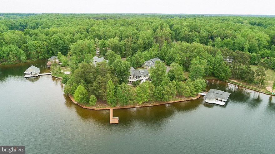 JUST REDUCED! 11/04/2021
 Amazing waterfront retreat on the southern part of the public side of Lake Anna.  Features breathtaking Sunset views located in highly sought Sycamore Shoals in one of the most popular spots on the lake.  Featuring over 600  feet of expansive water frontage with bulkhead and a boardwalk around the shoreline with panoramic water views, private boat ramp and a huge boat house  with 3 slips with electric lifts, jet ski slips, Tiki bar, a separate  large storage unit and a large sun deck along with  a large fishing and swimming pier.  This smartly-designed lake house living room has large floor-to-ceiling windows to showcase panoramic views of Lake Anna, floor to ceiling stone gas fireplace, wood cathedral ceiling,. bright recessed lighting, and beautiful flooring throughout.  Over 6500 sq. ft. on 3 levels.   The expanded Main level master suite with walk-in closet, sitting room, a gorgeous bathroom that features a  large walk-in  shower with travertine tile, large jacuzzi , and  double  vanities and awesome water views.  Main floor also includes a large open gourmet kitchen has plenty of counter space , kitchen island, Labrador brown granite countertops, ceramic tile floor and a breakfast area, separate formal dining room and office all with hardwood floors with unbelievable water views, The upper level has 2 large bedrooms and a  spacious loft and two full  baths.  Lower level has a massive recreation room,  2nd full kitchen, pool table room, ceramic floors and 2nd family room with a wood burning  fireplace and amazing water views and  a 2 car attached garage. Outside of the house, a large deck offers stunning views of the lake. A  massive 5  car detached garage/shed with a full bath and a second level for additional living space or storage equipped with  water and HVAC, lake fed irrigation and a paved driveway. Exquisite large back patio with water views galore . Extensive hardscaping along with a hot tub hot . The list goes on!! FURNITURE CONVEYS WITH AN ACCEPTABLE OFFER!