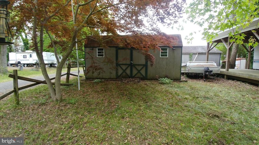 Located in Indian Acres Campground which is limited to 150 days a year no more than 100 consecutive days (not a full time residence). A very large corner lot (4748 sq ft) located on the back street in Glen 3. Trailer needs some work and has a build over that covers the trailer and the deck. Large shed for storage and plenty of parking.  Come with your boat, enjoy the pool, fish, play areas for children, convenience store, arcade, events all season and much more. A friendly fun-cation location where you own your own lot. I look forward to meeting you.