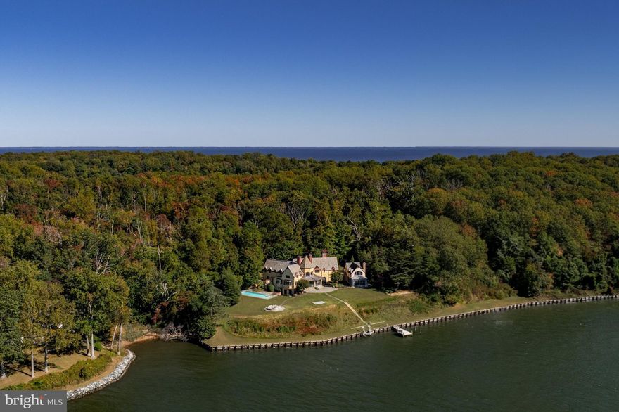 Gibson Island is one of the Chesapeake Bay’s crown jewels. Framed by the Chesapeake Bay on one side and a tranquil harbor on the other, the causeway offers truly breathtaking views in every direction.

A vision of the Olmsted Brothers in the 1920s, its approximately 200 private residences are dotted along meandering roads. Over two-thirds of the 1000-acre island are tree-covered, a large freshwater pond and nine-hole Charles Blair Macdonald golf course complete the landscape. Miles of scenic shoreline surround this secure gated sanctuary. Round-the-clock gatehouse staffing and a dedicated police force ensure an exceptional level of security and privacy for this close-knit community.

One of the most significant estates within this coveted enclave is 622 Magothy Road, a resplendent home that infuses European grandeur into its coastal surroundings. Distinguished and widely recognized for its iconic octagonal turret, the residence sits on over two acres of private, protected waterfront along the broad Magothy River at its inlet to the Chesapeake Bay.

A long driveway meanders through wooded surroundings before opening onto a circular motor court at the stately façade. Characterized by genuine stucco, a gorgeous graduated slate roof, and dormers integrated at the perimeter of the roofline, the estate evokes a sophisticated Normandy-esque yet coastal ambiance. The grand entrance is nestled beneath a protruding central gable, introducing a palatial floor plan spanning approximately 11,000 square feet of exquisite living space, featuring a solarium and stunning great room .

Gut renovated in 1999 with a major renovation completed in 2015, the interiors are supported by contemporary systems while striking a fine balance between modern livability and the preservation of historic elements. Perhaps the most stunning feature within the home is a dramatic pewter staircase railing that serves as a sculptural centerpiece. Formal rooms are generously proportioned and arranged to frame sweeping, 180-degree elevated water views from every large window. Throughout are seven fireplaces, including a large hearth in the great room, which infuse the expansive spaces with a sense of warmth and timeless character.

The heart of the informal areas is a chef’s kitchen, lined with reclaimed imported stone floors from France and revolving around a stunning 19-foot island that creates a central gathering place. The upper-level primary suite occupies a dedicated wing and showcases elaborate dressing rooms and a lavish bath. Four additional bedrooms, three on the upper level and one on the lower level, are ample in scale and feature ensuite bath. A three-car garage and whole-house backup generator complete the picture.

Perched on a hilltop with unparalleled vistas of Magothy sunsets, verdant canopies, and sparkling waters, the manicured grounds are home to towering century-old trees and mature gardens. The covered terrace steps down to a broad patio, off of which branches a walking path leading directly to the water’s edge. A private dock with a boat lift enhances the waterfront experience, while a large lap pool is tucked discreetly to the side of the main residence.

The Gibson Island Club offers an exceptional array of activities and amenities for residents and guests alike, including boating, tennis, swimming, and championship golf. Access to the Club is offered through a membership process and is not automatically conveyed with the property.

A rare generational offering, 622 Magothy Road is among the most distinguished and fleeting examples of waterfront living. It seamlessly blends the serenity and seclusion of island life with exceptional accessibility. The estate is located in close proximity to Washington, D.C., Baltimore, and Annapolis, all without the need to cross the Bay Bridge. This unique combination of natural beauty, architectural refinement, and metropolitan convenience defines a lifestyle that is both effortless and extraordinary.
