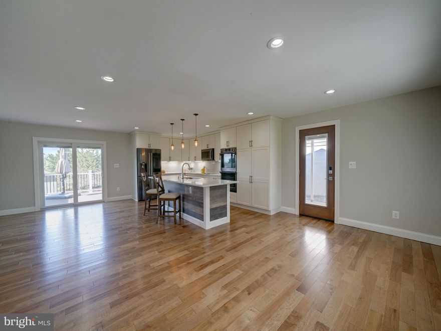 Don't miss this meticulously upgraded split level located on a tree-lined corner lot featuring 4 bedrooms, 2.5 baths with detached 2 car garage in Mt Airy! Need a place to park your RV? Look no further... this home also includes a 95'x18' parking pad on the side of the property. Owner has made numerous updates to this home both inside and out. Complete renovation started in 2018 including interior and exterior improvements - custom designed kitchen, floors, lighting, light switches, trim, bathrooms, doors, sliding door, siding, roof, and other improvements, too numerous to list. More recently, the HVAC system & smart thermostat (2025), gutters & concrete under carport / porch (2026) were all replaced. Enter the home from the front covered porch or via the side door from the carport. On the first level, there is a great room and kitchen, allowing for many different configurations of for living / dining / entertainment space. This dream kitchen includes shaker cabinetry, white quartz counters, Samsung black stainless steel appliances with induction cooking, ceramic tile backsplash, under cabinet lighting, large island/breakfast bar and a pantry. Dining area adjacent to kitchen has space for a large table with gleaming hardwood floors and a country view. Walk out the slider to the rear trex deck. From the 1st floor, walk down half a flight of steps to the the lower level, with an open family room with wood burning fireplace, half bath, 4th bedroom, laundry room and access to the unfinished basement. Upstairs, find 3 bedrooms, a linen closet and 2 full bathrooms. All bedrooms thoughtfully updated with hardwood floors and ceiling fan with light. The primary bedroom has 2 walk-in closets and an attached en-suite bathroom with upgraded double rainfall shower head, handheld showerhead plus 4 body jets and a double vanity sink with granite counters. 2 additional bedrooms and hallway full bath with laundry chute. Washer and dryer located on the lower level. 10 private driveway spaces, 1 carport space, detached 2 car garage parking plus RV/camper parking pad at far right of property. The gutter systems for the front and rear of the home have been completely redone in March. The home is conveniently located off 70/27. Call your agent to schedule a tour today!