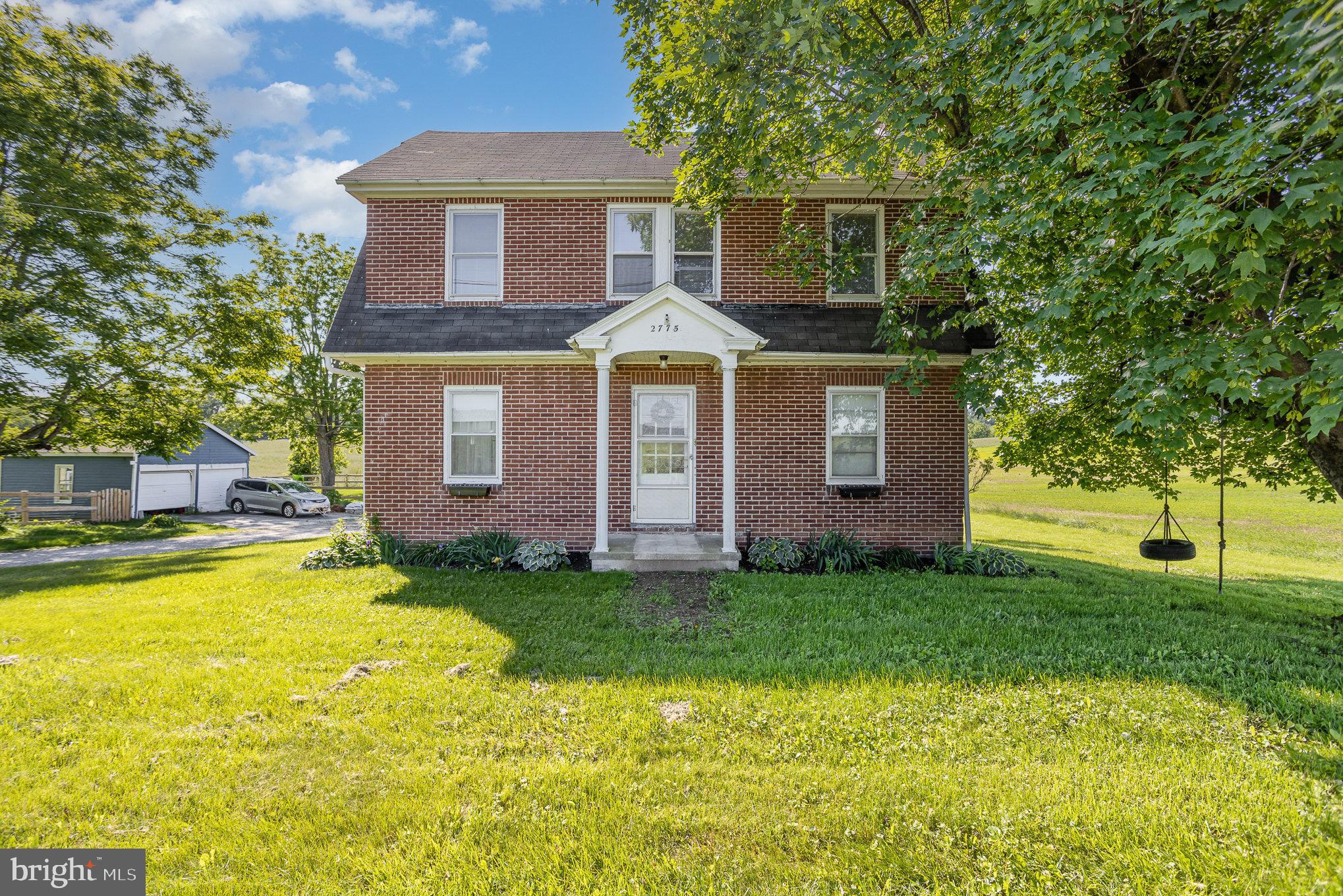 Looking for a peaceful rural setting with room to roam—but still want to stay close to major routes and conveniences? This is the one! Situated on the outskirts of West Manchester Township, this all-brick farmhouse offers the perfect blend of country charm and modern updates.
Just minutes from Route 30 and convenient to Spring Grove, Southern York County, and the rail trail, this 4-bedroom home sits on a generous 0.59-acre lot—perfect for outdoor activities & gatherings.,
Inside, you’ll find a beautifully updated kitchen with original hardwood floors and 7" baseboards throughout. The main floor features a spacious double living room with a half bath, a dining area, and a bright white kitchen with new stainless steel appliances, newer countertops and flooring, and updated lighting and ceiling fans.
Upstairs, the second floor offers three bedrooms and a remodeled full bath. Don't miss the finished third floor, offering a fourth bedroom plus a sitting area or home office.
The home is heated with electric baseboard units (installed in 2020) and a wood stove in the lower level for cozy supplemental heat. Major upgrades include updated electric throughout the home and garage. The detached garage boasts 60-amp electric and storage above—ideal for a workshop or hobby space.
Enjoy sunset views from the rear porch. With plenty of parking and elbow room, this property is perfect for anyone who loves the outdoors.