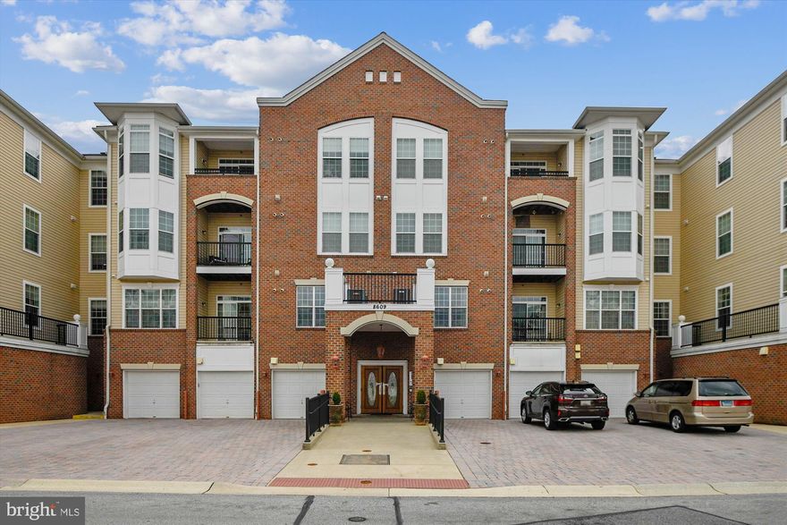 Welcome to your serene oasis in Piney Orchard's vibrant 55+ community. This gorgeous 2-bedroom, 2-bathroom condo stands out with its stunning hardwood floors, abundant natural light, and tranquil, wooded views from your private balcony. Enjoy the convenience of an attached garage that leads directly into the building. The versatile den, with its custom wood doors, is perfect as an office or can easily transform into a formal dining room, crafts room or whatever you desire. The freshly painted kitchen offers plenty of storage, with a built-in pantry and room for a table. The Owner’s suite boasts a cozy sitting area, two closets, including a large walk-in closet, and an updated spa-like bathroom. Located in a secured building with an elevator, and access to all the amenities Piney Orchard has to offer, this move-in-ready condo has it all. Schedule your appointment today to see the difference.