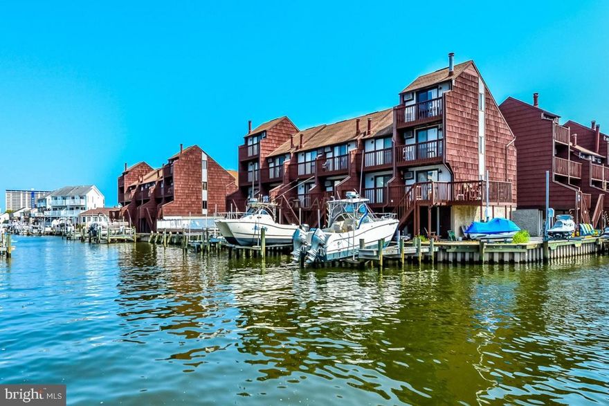 Everything you are looking for in a bayside condo. Great view of bay, many newer appliances and newer wood grain laminate flooring.  Wood burning fireplace and dock also come with this spacious unit with 4 decks.  Under the unit parking for protection of your vehicle. Waterfront pool