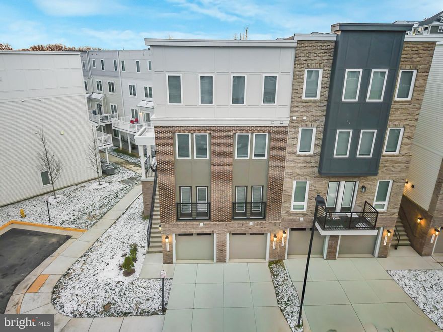 Welcome home to 15535 Smoke Box Way, where style, space, and convenience come together in the highly desirable Rippon Landing community. From the moment you arrive, the stately exterior and classic curb appeal set the tone for what’s inside. Step through the front door and be greeted by a thoughtfully designed, multi-level layout that lives like a townhome while offering the ease of condo living.
The main living level is the heart of the home—bright, open, and ideal for everyday living or entertaining. The gourmet kitchen steals the show with an oversized island, abundant cabinetry, sleek stainless steel appliances, and room to gather. Just off the kitchen, step onto your private balcony—perfect for morning coffee or evening unwinding. The spacious living and dining areas flow effortlessly, complemented by a convenient powder room. Upstairs, the second level features two generously sized bedrooms and a full bath, offering flexible space for guests, home offices, or hobbies. The top floor retreat is dedicated entirely to the owner’s suite, creating a true private escape. Double doors open to a spacious bedroom, large closet, and a spa-inspired en-suite bath with a beautiful shower, dual vanities, and a private water closet. A full-size laundry room on this level adds everyday convenience right where you need it most. The lower level expands your living options even further with a versatile family room—ideal as a media lounge, another guest room/space, game room, playroom, or creative studio. An electric fireplace adds warmth and character, while an additional half bath and direct access to your private garage complete this level.
Location is a standout feature. Rippon Landing offers exceptional commuter access with the VRE Rippon Station just minutes away, making travel to Washington, DC, Alexandria, and beyond effortless. Easy access to I-95, Route 1, commuter lots, and public transit keeps you connected, while nearby shopping, dining, parks, and waterfront amenities ensure everything you need is close to home. This is low-maintenance living without compromise. Space, style, and a commuter-friendly location all wrapped into one incredible opportunity. Schedule your private showing today and experience why this home stands out from the rest.