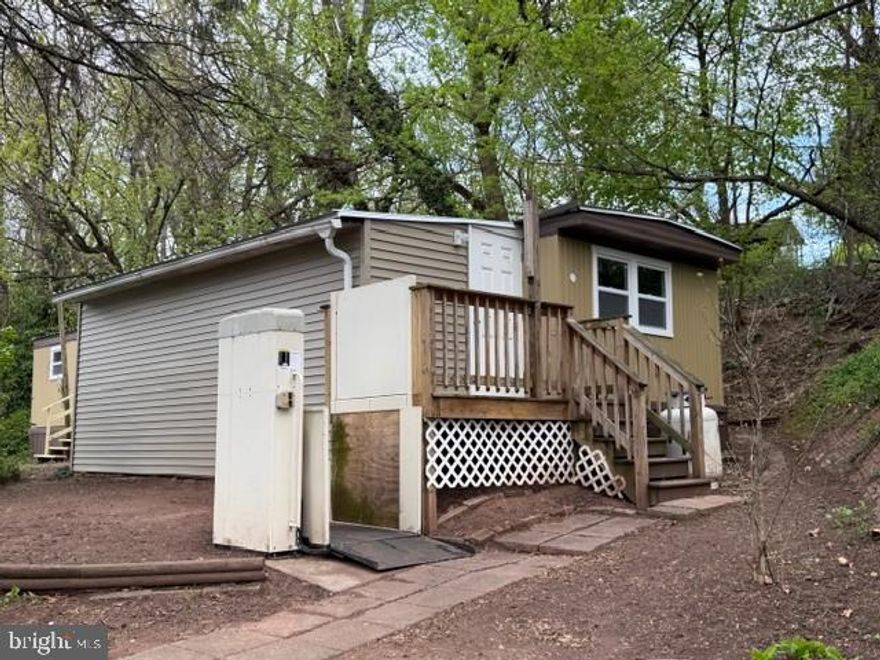 Welcome to 20 Oakland Manor.  This 3 bed, 1 Bath home has been remodeled from top top to bottom.  New metal roof, new windows, new LVP and wall to wall carpet flooring,  new water heater, new plumbing, fresh paint inside and out, recessed LED lighting throughout.  Driveway is large enough to fit 4 vehicles.  Escape to the private patio area out back through the french doors. Large shed for additional storage.  Hookups in laundry closet ready to go for stackable washer and dryer.  Wheelchair lift.  Low lot rent at only $425/month and includes sewer.