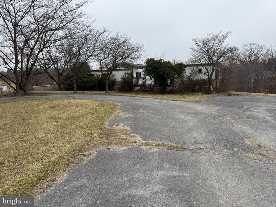 **This property is not vacant.  The owner doesn't have a car.  Please do not tour the yard without a scheduled appointment.  This home is being sold as-is and requires significant work and tender loving care (TLC). It is situated in a beautiful scenic location with numerous options and possibilities. The property features a 2-bedroom, 2-bathroom trailer with an additional family room built on, sitting on a picturesque lot of just over an acre and a half. The home is connected to public sewer and has its own well. Please note that one bedroom and bathroom are currently not usable due to flooring issues caused by a water leak. Interior photographs will not be provided.