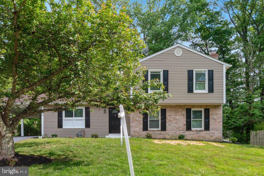 Recently renovated single-family home in Catonsville, Baltimore County. A long driveway with a carport provides easy access directly into the kitchen. Inside, the home features durable LVP flooring throughout, four bedrooms (three upstairs and one in the finished basement), and 2.5 bathrooms. The updated kitchen includes granite countertops, new stainless steel appliances, white subway tile backsplash, brand new cabinets, recessed lighting, and updated fixtures. A large island separates the kitchen from the living room, where a brick fireplace serves as the focal point. The main level also offers a convenient laundry area and a well-placed half bath for guests. Upstairs, all three bedrooms are generously sized, with the primary bedroom offering multiple closets and an en-suite bath. The basement provides a spacious finished area ideal for a rec room, home theater, or game day gatherings.