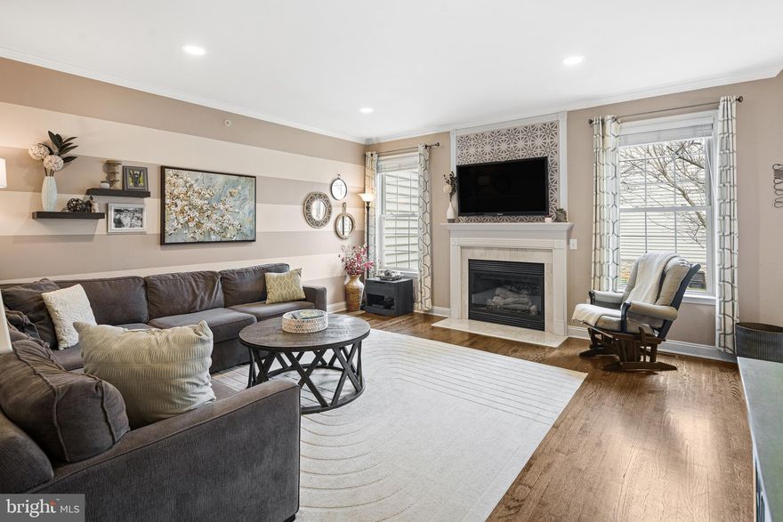 This stunning townhome is perfectly situated in the desirable Hillcrest Glen community and offers a thoughtful blend of style, space, and functionality. Step inside the long foyer leading to a formal dining room or flexible living space with a walk-out bay window. The great room features nine-foot ceilings, crown molding, hardwood floors, and a cozy gas fireplace with a traditional mantle, opening seamlessly to the large kitchen. The kitchen is equipped with 42” cabinets, countertops, a double sink with goose-neck faucet, stainless steel gas stove, side-by-side refrigerator, built-in microwave, recessed lighting, a spacious pantry, and an adjoining eat-in area that opens to a private deck—perfect for entertaining. Upstairs, the primary suite offers a large sleeping area, walk-in closet, ceiling fan, and spa-like bathroom featuring dual vanities, a stand-alone shower, and a deep soaking tub. Two additional bedrooms are generous in size with double closets, ceiling fans, and decorative moldings, while a convenient upstairs laundry adds everyday ease. The finished lower level now includes a 4th bedroom with egress and a full bathroom, ideal for guests or extended family, plus ample storage. Major home systems have been updated for peace of mind: roof (2025), AC (2019),  Heater (2021) and water heater (2023). Located near the sought-after Borough of Conshohocken, with quick access to Route 476, the PA Turnpike, shopping, and services.