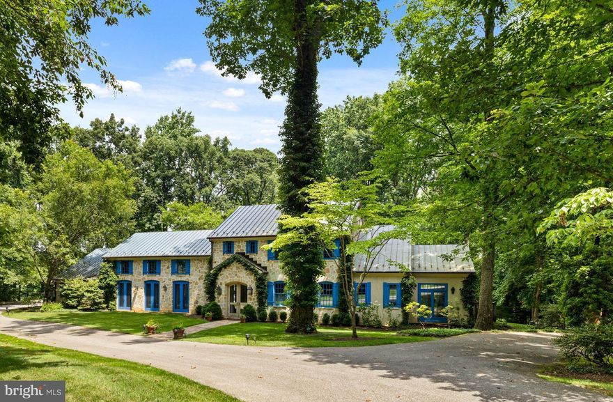 Beautifully sited among the luxury estate homes of The Residences of Caves Valley in Caves Valley Golf Course, this storybook stone and stucco residence is built in the Country French tradition, with magnificent bespoke design boasting finest finishes and highest level craftsmanship throughout. Arched, glazed double doors open to the barrel-vaulted Foyer with dual access to the stunning vaulted Great Room with reclaimed wood ceiling trusses and expansive, full window wall opening to patio and pool, affording breathtaking, brilliantly bright views. Expansive, gourmet Kitchen/ Breakfast Room with deep bay window and custom window seat awash with sunlight, with adjacent butler’s pantry for added storage. Lovely office with extensive built-ins. Luxurious main level Primary Suite comprised of large Bedroom with direct access through full window wall to pool deck and garden, marble spa Bath, Gym/Yoga Room and amazing, multi-space Dressing Room complex. Laundry Room, Mudroom/Pool Changing Room and 2-car Garage complete the main level. The Library Loft overlooking the Great Room leads to 3 en-suite Bedrooms on the 2nd Level. Lower Level with full Bath and tremendous storage areas. Expansive new flagstone patio and pool decking, heated pool with 2 year new auto-cover surrounded by extensively landscaped, impeccably maintained 2.47 acres.