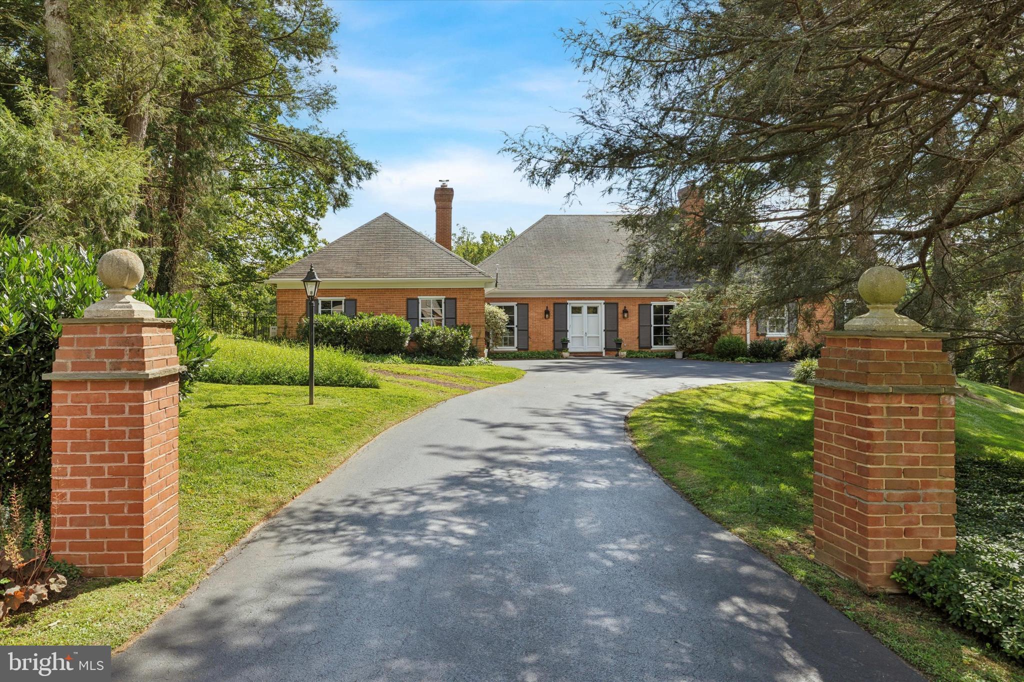 With an enduring sense of graciousness throughout, this stunning Williamsburg-style home welcomes you the moment you arrive. This home combines timeless architectural details with thoughtful modern updates. Perfectly situated on a private cul-de-sac in the Northside of Bryn Mawr surrounded by mature plantings on a full acre of serene grounds. Step through the double doors into a welcoming entryway, featuring a spacious coat closet with a powder room down the hall. The living room showcases a wood-burning fireplace and dramatic floor-to-ceiling windows, filling the space with natural light. The heart of the home with picturesque views of the back yard is the expanded gourmet kitchen, a true showpiece boasting: Custom Cabinetry and an AGA Brand Range with a Broan Eclipse Ventilation System, over 12 feet of Suede Marble Island (with a 15 year seal), Pendant Lighting over the Island, Recessed Lights throughout the Kitchen and the Dining Room, Glass and Marble Backsplash, Farm Sink, Oversized Pull-Out Pantry, Paneled Refrigerator, Built-in Wall Units with Shelving and a Bar Area. This chef's haven flows seamlessly to a sun-filled dining space enhanced with a striking chandelier and French doors leading to a spacious patio and deck-perfect for entertaining. All hardwood floors have been recently refinished, gleaming throughout the entire home. The primary suite is a private retreat featuring serene backyard views, a spa-like bathroom with porcelain tile floors, glass shower with custom tile work, quartz countertops, custom lighting and four custom closets-one thoughtfully designed for shoes and three dedicated to clothing-offering both luxury and organization and a dedicated charging nook. Three additional bedrooms, including one with a wood burning fireplace currently being used as an office, with ample closet space, a cedar closet and full tile hall bath complete this level.
The walk out lower level includes an in-law suite with a full bathroom, another wood burning fireplace, laundry, ample storage, and direct outside access to a covered patio. With a lower level that spans the entire square footage of the home, you'll have abundant space for recreation, entertaining, or creating your dream retreat. There is also opportunity to expand on the second floor if desired. Additional highlights include a two-car garage, multiple outdoor living spaces, and complete privacy on one acre of landscaped grounds. This Bryn Mawr gem offers a rare combination of classic architecture, modern luxury, and enduring charm, it is more than a place to live-it's a statement of enduring elegance. All this and just minutes from top-rated Lower Merion Schools, restaurants, shopping, trains, and everything the Main Line has to offer.