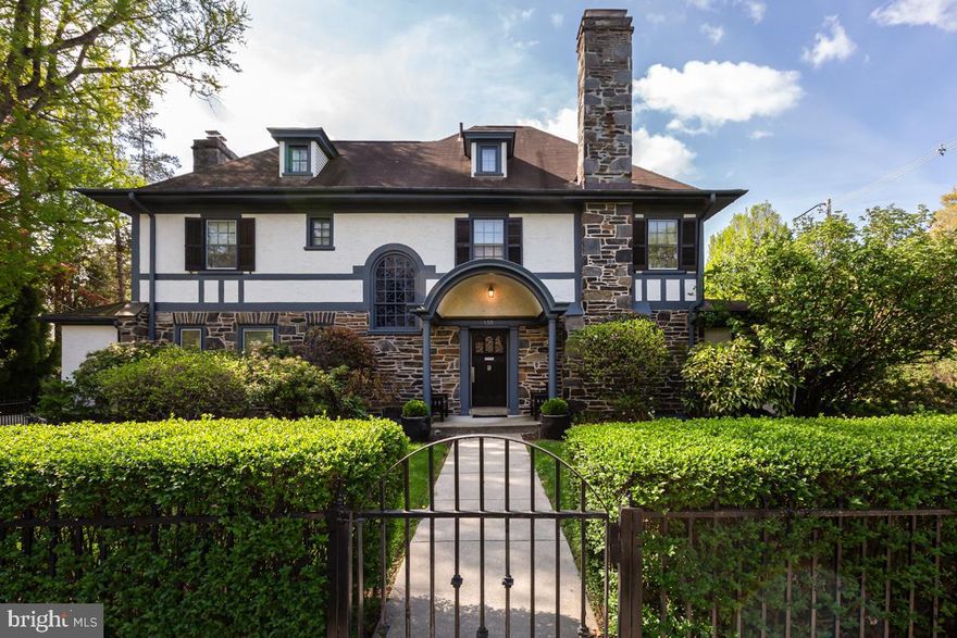 Tucked behind manicured hedges and a charming metal gate, this beautifully maintained, move-in ready, 5-bedroom, 3.5-bathroom Colonial welcomes you with an elegant arched portico entry. Inside, a striking foyer with classic black-and-white checkered tile floors sets the tone for the home’s timeless character and refined style. The sunlit living room features rich hardwood floors, recessed lighting, crown molding, and a wood stove fireplace with a distinctive green tile surround and crisp white mantle, while the inviting family room offers a warm, relaxed retreat with plush carpeting and a stunning exposed stone wall. Through pocket doors from the foyer, the formal dining room is thoughtfully designed for entertaining, complete with a statement chandelier, crown molding, and abundant natural light. The eat-in kitchen blends function and style with granite countertops, stainless steel appliances, a built-in range and dishwasher, double ovens, pendant lighting, and a large pantry, with a convenient powder room just steps away. 

An arched stained glass window adds a touch of charm and architectural detail along the stairwell to the second level. The spacious primary suite is a true retreat, featuring crown molding, custom window treatments, a comfortable seating area, generous closet space, and an ensuite bath with a stall shower and separate wood vanities.  Additional bedrooms offer comfort and flexibility, including two well-sized bedrooms with crown molding and ample closets, a full hall bath with a subway tile tub/shower combination. On the third level, a fourth and fifth bedroom, one currently used as a home office, share a hall bathroom. All bathrooms throughout the home have been thoughtfully updated with a cohesive, timeless aesthetic. The finished full basement expands the living space with carpeting, recessed lighting, beadboard accents, and a dedicated wine cellar room. Outside, the home truly shines with lush, meticulously maintained landscaping and gardens, including a serene zen garden and a lovely patio with a hot tub, creating a private outdoor oasis ideal for relaxing or hosting.  A detached two-car garage with a loft completes this exceptional property, ideally located within the top-rated Lower Merion School District and offering easy access to local parks, shops, restaurants, as well as Route 1 and I-76.