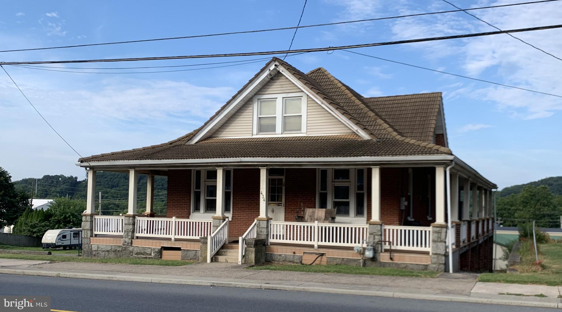 Brimming with character and potential, this five-bedroom, one-bath home is ready to welcome a new owner with imagination, creativity, and heart. Set on a generous lot in the heart of Hamburg, the property features a rare four-sided wraparound porch—an ideal perch for enjoying the beloved King Frost Parade or simply soaking in quiet evenings. With ample off-street parking for family and guests, a spacious yard for play or gardening, and a 2½-car detached garage, the home offers both convenience and versatility. Inside, the layout invites transformation, with two expansive attic rooms—one boasting a cedar closet—waiting to be reimagined as studio space, guest quarters, or a cozy retreat (heat required). Whether you're drawn to its vintage charm or inspired by its possibilities, this home is a canvas for your vision and a place to make lasting memories.