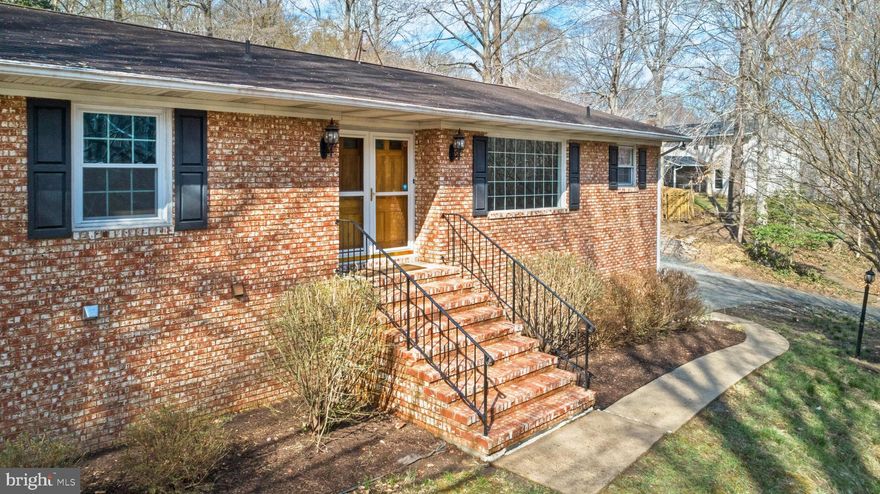 As you approach this all brick rancher in Hardesty Estates you will see the serene stone waterfall/pond feature that runs along the side of the driveway.  Situated at the top of the hill on a 1.1 acre private lot this home offers 3000+ SF of living space.   The basement is finished with a large family room and fireplace, storage closets and a small kitchenette which could give the option of an in-law/au pair suite.   Access to the two-car garage is on this level.   On the main level there are hardwood floors throughout.   The kitchen has an oversized window for lots of natural light where a table would fit nicely.   The kitchen floors are slate, the countertops are granite and the refrigerator, microwave and stove have been replaced in the past two years.   The living room offers a second fireplace with a brick wall and plenty of space for gatherings.   outside you can relax on the ack porch which overlooks the large rear yard, fully fenced with a pergola entrance from the driveway.   A 12/24 shed offers additional storage and there is a concrete pad and electrical outlet if you want to have a hot tub.    Retaining walls and flower beds surround the driveway parking area.  Pets are considered on a case-by-case basis.    No smoking.   $40 credit check fee, good credit and income required.