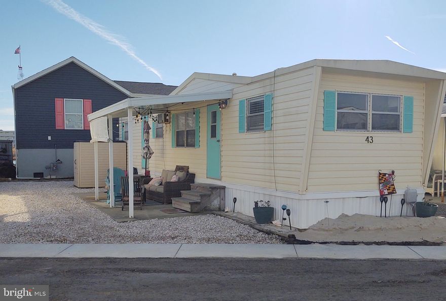 What an opportunity...Here it is!  A delightful, cozy 2 BR Mobile...with a nicely covered patio for your grilling & entertaining...PLUS Parking for THREE Cars!  AND INCLUDES BOAT SLIP #22, with water & electricity!  Welcome to Warrens Park--a mid-town unique Bay Side Waterfront Community.  Ownership of this Lot & Boat Slip comes with 2350 shares of Warrens Park, Inc., a MD Corp.  Your low monthly cost of $206... COVERS The Following:  Your Annual Real Estate Property Taxes! Your Public Water & Sewer Fees!  Also covers management & maintenance of Roads, Bulkhead, a Private Boat Ramp! new Fish Cleaning Table/area with running water!  Plus covers two smaller common area piers  w/steps into the water for swimming, fishing, crab pots, clamming, paddle boarding, kayaking & lots more!  There is also an on-site storage area to store your boat & trailer, plus slips to rent and purchase as they become available.  Can you believe - all of the above for only $206./mo.  Where else in OC can your ownership cover so much!  And, as an extra bonus you are right here to enjoy OC's Spectacular Sunsets...plus being across the street from our fabulous Beach!  It's like having the Best of Both Worlds.  Your choice...will this property be your Beach Get-Away Vacation Home or will you relocate for year-round living.  Call today to set up your appointment.