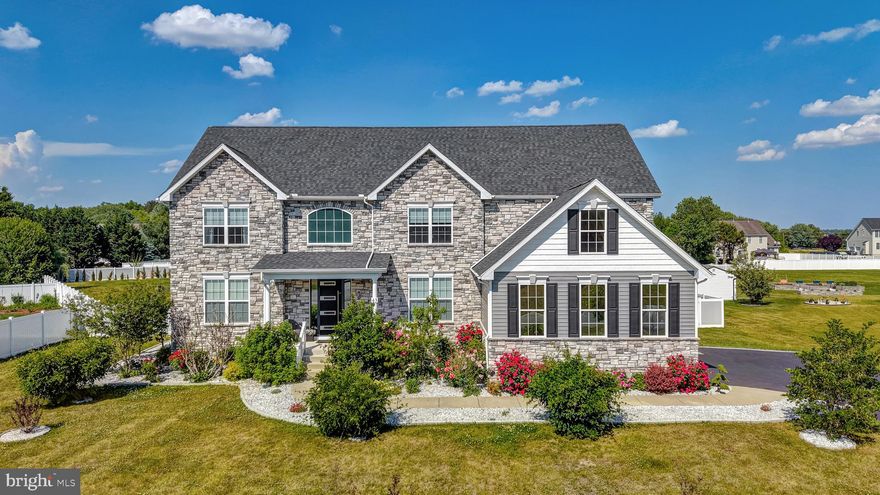 Welcome to this extraordinary custom-built luxury residence located in the heart of Dover, where elegance, craftsmanship, and thoughtful design come together to create a truly one-of-a-kind home. Perfectly situated close to Delaware beaches, shopping, restaurants, entertainment, and major routes, this stunning property offers both convenience and upscale living at its finest.
From the moment you arrive, you’ll immediately notice the extensive custom upgrades and striking curb appeal, featuring a full stone exterior façade, modern architectural enhancements, an oversized imported front entry door, extended driveway with pavers, professionally landscaped grounds, and over an acre of fully fenced property surrounded by beautiful gray and white modern fencing, Italian Cypress trees, willows, and custom stone landscaping.
Step inside to experience a bright, open-concept design with soaring ceilings, imported custom lighting throughout, and a breathtaking statement chandelier equipped with a custom motorized lift system for adjustable height and effortless maintenance. The entire home was thoughtfully redesigned from the original builder plans to create a more luxurious and spacious flow, including opening up the entire main living area and transforming the layout into an elegant open catwalk design.
The first floor features upgraded luxury vinyl flooring throughout, custom modern doors, upgraded moldings, custom paint selections, and remote-controlled blinds and curtains in nearly every room. The private office showcases electronic remote-controlled window treatments and upgraded custom doors, while an additional flex room near a nearby bathroom and closet offers versatility for a library, guest suite, or additional office space.
The gourmet kitchen was fully upgraded with premium stainless steel smart appliances, custom backsplash finishes, and seamless integration into the expansive dining and family room areas. The dramatic living room features a floor-to-ceiling custom stone fireplace wall, oversized custom windows, and designer ceiling-height curtains that elevate the entire space.
Upstairs, the home was completely reimagined and customized beyond the original floor plan. What was originally designed as four bedrooms was transformed into two oversized luxury suites and a spacious princess suite, each featuring private bathrooms and custom closet spaces. The secondary owner’s suite offers a massive dual-sided closet, while the primary suite delivers a true luxury retreat with blackout custom window treatments, spa-inspired finishes, and separate his-and-her custom walk-in closets thoughtfully designed for maximum comfort and organization.
The primary bathroom was extensively upgraded with expanded tile work, a widened luxury shower, premium fixtures, and a spacious open design that creates a true spa-like atmosphere.
The fully finished basement adds an incredible amount of living and entertaining space. Originally designed as partially unfinished utility space, the basement was fully opened and transformed into a custom entertainment level featuring additional rooms including a poker room, bar room, gym-ready space, extensive storage areas, epoxy flooring, upgraded modern doors, and rough-in plumbing already completed for a future full bathroom installation. A second sump pump system with additional flood-prevention upgrades was also added for peace of mind.
Additional premium features include:
• Fully finished and epoxied 2-car garage
• Massive overhead garage storage with pull-down stair access
• Three-zone HVAC system with separate climate control for each level
• Upgraded landscaping and grading with the home elevated approximately four feet for additional drainage protection
• Leaf guard gutter protection throughout
• Custom fencing enclosure for trash storage
• Smart home features and upgraded lighting systems throughout
• Extensive custom trim work, finishes, and post-builder luxury enhancements.