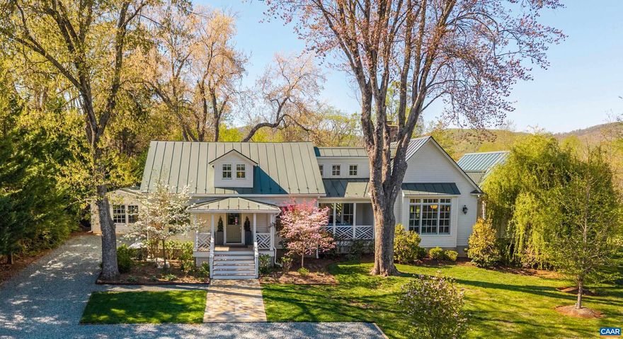 Turnkey with fully upgraded systems, and interior designs by the Owner, this Virginia Tidewater style cottage sits in the heart of the Keswick countryside only 10 miles east of downtown Charlottesville, offering a practicality of scale that exemplifes humble elegance and modern comfort. The pitched gable standing seam metal roof provides soaring interior ceiling heights and strong structural integrity. The front and back covered porches offer seamless outside access and comfortable country living with a stone surround fireplace. The main level primary suite features large windows that frame landscaped and distant mountain views, a walk-in closet with custom cabinetry and lighting, and a luxurious bathroom with double vanity, tile and glass shower and full size tub. The living room has a central fireplace flanked by French doors offering natural light into the refined and curated living space that flows seamlessly into the dining area and gourmet galley kitchen with marble countertops and premium appliances. The first level has a custom second bedroom and full bath, and a large laudry/utiilty room. Upstairs is a third bedroom with a study and full bath. There is a charming, conditioned studio space off the kitchen and side patio.,Marble Counter,Wood Cabinets,Exterior Fireplace,Fireplace in Living Room
