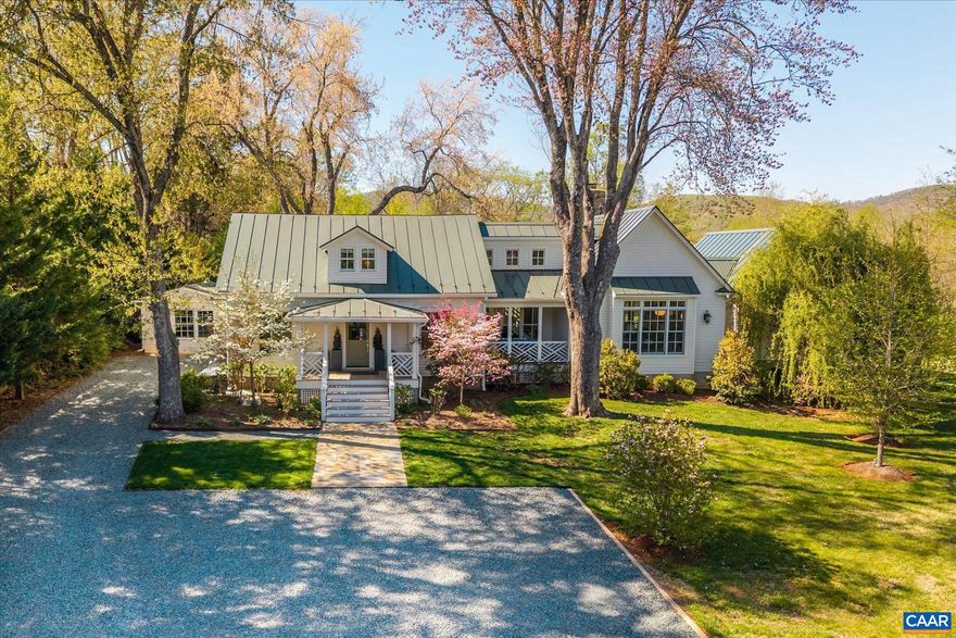 Turnkey with fully upgraded systems, and interior designs by the Owner, this Virginia Tidewater style cottage sits in the heart of the Keswick countryside only 10 miles east of downtown Charlottesville, offering a practicality of scale that exemplifes humble elegance and modern comfort. The pitched gable standing seam metal roof provides soaring interior ceiling heights and strong structural integrity. The front and back covered porches offer seamless outside access and comfortable country living with a stone surround fireplace. The main level primary suite features large windows that frame landscaped and distant mountain views, a walk-in closet with custom cabinetry and lighting, and a luxurious bathroom with double vanity, tile and glass shower and full size tub. The living room has a central fireplace flanked by French doors offering natural light into the refined and curated living space that flows seamlessly into the dining area and gourmet galley kitchen with marble countertops and premium appliances. The first level has a custom second bedroom and full bath, and a large laudry/utiilty room. Upstairs is a third bedroom with a study and full bath. There is a charming, conditioned studio space off the kitchen and side patio.,Marble Counter,Wood Cabinets,Exterior Fireplace,Fireplace in Living Room