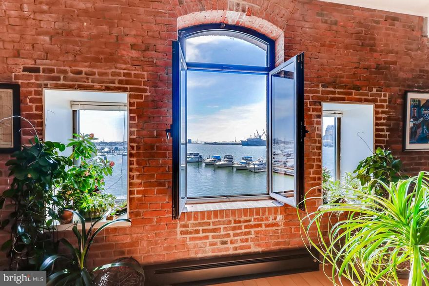 Truly breathtaking water views from this CORNER waterfront updated two bedroom single level condo in Henderson's Wharf.  Stunning UNRESTRICTED Water views from every window in the unit, which includes views from both Bedrooms, Living room, Dining Room and Kitchen. The unique wonderfully open floor plan offers exposed brick, high ceilings, custom lighting, & hardwood throughout. Entertain in a gourmet kitchen with a huge island with granite and stainless steel appliances. The condo also offers an updated master bedroom, oversized walk-in closet,  and luxurious bath suite. Garage parking space included. Take advantage of the possibility of living in a secure building with a newly renovated lobby,  a 24-hour front desk, elevators, garage parking, elegant common areas including a serene courtyard, fitness center, and one of the best locations in historic Fells Point. Walk to hundreds of restaurants but live at the end of the quiet peninsula where the calm of the water welcomes you home. There is no place quite like Henderson's Wharf and this is truly one of the finest condos in the building! Please take a minute to view our Video Tour of Fells Point and 1000 Fell street # 322.