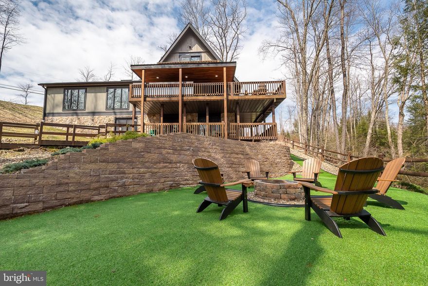 Enjoy lakefront living at its finest in this beautifully remodeled home with a private dock. Thoughtfully updated with modern finishes including a kitchen remodel, new windows and doors, new upper balcony, new flooring throughout, and recently added mini splits on the lower level. This property offers stunning water views, an open-concept layout, five bedrooms (three of which are en suites), and two-family rooms. The exterior space offers seamless indoor-outdoor living that includes a built-in bar area with a Blackstone grill and a firepit area off the lower level, perfect for relaxing or entertaining. Whether you're seeking a full-time residence or weekend getaway, this home delivers the ultimate waterfront lifestyle.