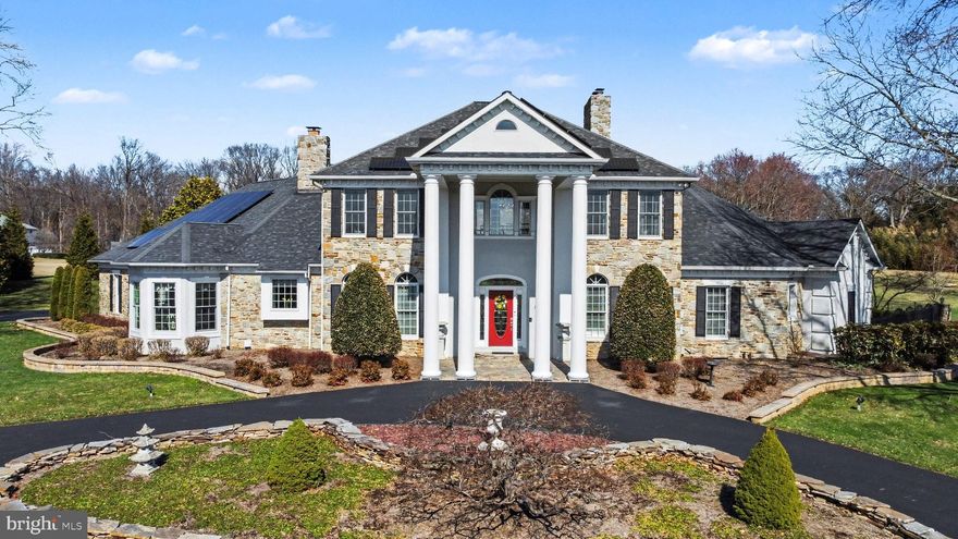 Experience elevated living in this extraordinary home set on 3.6 private acres in the heart of Fallston. Showcasing over 7,600 square feet of refined interior space, this stunning Colonial Revival with grand Neoclassical presence makes an unforgettable first impression with its stately columned façade and commanding curb appeal. Inside, sophistication meets comfort with beautifully appointed living spaces designed for both  entertaining and everyday living. The dramatic two-story living room is a true showstopper, featuring a soaring wall of windows that floods the home with natural light, along with a floor to ceiling stone fireplace with pellet stove that adds warmth, character, and cozy ambiance. The main-level primary suite offers a private retreat, complete with a wood-burning fireplace and French doors that open directly to the patio and pool area—creating a seamless indoor-outdoor experience and a true resort-like feel.  The en suite primary bath provides a spa-like experience with a steam shower and soaking tub. The upper level features a bedroom with an ensuite bath, along with two additional bedrooms that share a Jack-and-Jill bathroom. The finished lower level adds versatility and value, complete with a bonus room with a full bath - ideal for a 5th bedroom, executive office, fitness space, or creative studio—tailored to fit your lifestyle. Seamless indoor-outdoor living awaits as French doors along the length of the house lead  to an expansive brick paver patio overlooking your own private resort. The backyard is nothing short of exceptional—featuring a pristine inground gunite pool,  hot tub, and inviting fire pit, all surrounded by lush, landscaped grounds offering the ultimate in privacy and tranquility. This is more than a home—it’s a statement property. A rare opportunity to own a premier home where luxury, space, comfort, and setting come together flawlessly.