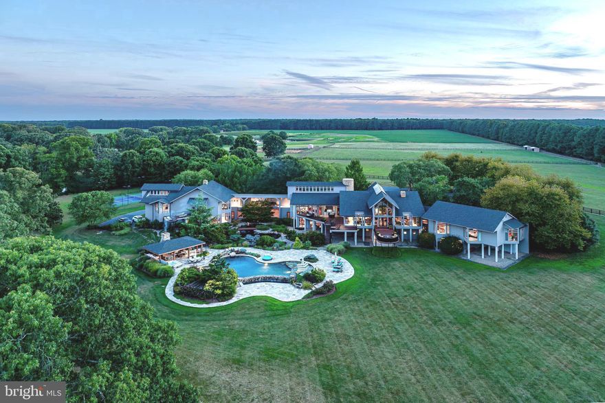 Stock Range Farm spans 350 acres of prime waterfront and is available for purchase in its entirety or with reduced acreage including the main residence. Options include selling the main house with 20+,40+,or 100+ acres.. **See documents for potential lot revisions and call listing agent for more details.
The property is free of easements and includes development rights, subject to all applicable Talbot County zoning regulations.

With vast working farmland and resort-style amenities, this rare gem truly combines luxury and sophistication with seclusion and tranquility. The 12,000+ sq. ft. primary residence showcases the breathtaking stylings of acclaimed architect Peter Jay Zweig and exemplifies the pinnacle of luxury living.  Built by Ilex Construction, striking architectural details and unparalleled craftsmanship are demonstrated throughout, seamlessly integrating with the breathtaking beauty of the landscape.

This magnificent home is filled with an abundance of natural light and boasts panoramic views, thanks to soaring glass walls that overlook the tranquil waters of Pickering Creek, expansive fields, and picturesque vineyards. The thoughtfully curated interior includes spacious living areas, a stunning owner's wing that offers privacy and comfort, and a separate guest wing that features a full kitchen, providing ideal accommodations for family and visitors. High-end features abound, including a gourmet kitchen, recreation room complete with kitchen and bar for entertaining, full exercise room, 5 car garages, elevator, heated limestone floors, Venetian plaster walls, and multiple outdoor decks. At every turn, this property exudes the loving care it has received.

Outside, the resort-style amenities include a large, heated infinity pool, complete with waterfall and hot tub, stunning pool pavilion with full outdoor kitchen, stone fireplace, and two TV’s and AV system. Along with the waterside tennis/pickleball court, tranquil koi pond, and private pier with 4-5’MLW, the opportunities for outdoor fun and relaxation are boundless.

In addition is the beautifully renovated 4-bedroom guesthouse with views of the vineyards, providing comfortable accommodations for family and friends. A well-equipped 9-stall barn includes a tack room/office, kitchenette, and a riding ring, complemented by 20 acres of fenced pastures.

There is also a 3-4 BR caretaker's cottage, a fully outfitted greenhouse, large equipment barn complete with an office and full workshop, and hay barn for storage. The property also offers excellent hunting opportunities, making it a versatile retreat for outdoor enthusiasts. 

The highlights of this extraordinary property continue through every acre, including sweeping landscapes and hardscapes, 200 acres of working farmland, 5 acres of vineyards, and a 6-acre stocked pond with private island. 

Unparalleled in its mix of tranquility and luxury, the opportunity to experience the very best of the Eastern Shore’s refined lifestyle and natural beauty is only possible at Stock Range Farm.

Please don't drive in driveway as there are security cameras and alarm. All appointments must be made with listing agent and additional information and details are available upon request.