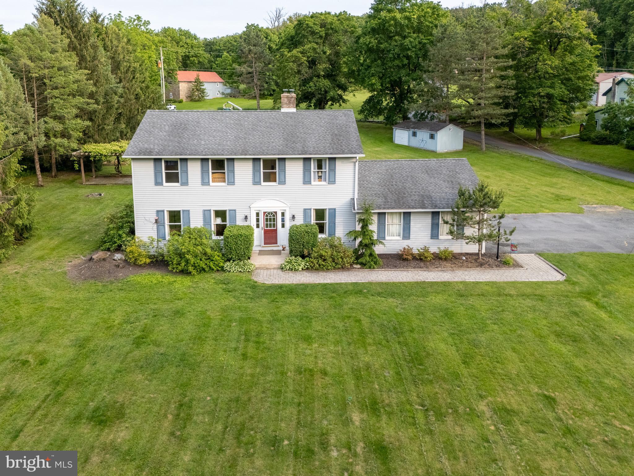 Beautiful 2-story Colonial situated on 1.48 acres in Brandywine SD. This property looks and feels spacious, offering a perfect blend of space, comfort, and thoughtful updates. Featuring 4 bedrooms, 2 1/2 baths, and a 2-car garage, the home includes elegant crown molding and warm bamboo flooring, adding a touch of character and continuity to the main living spaces. The eat-in kitchen, remodeled in 2017, features granite countertops, a ceramic tile backsplash, stainless steel appliances, a breakfast bar, and a dining area. The formal dining room opens to the rear deck—perfect for indoor/outdoor entertaining. The main level also offers a cozy living room, a flexible office or family room, and a convenient laundry room. Upstairs, the spacious primary bedroom includes a walk-in closet and private bath. Three additional bedrooms and a full hall bathroom complete the second floor, with Bedroom 2 offering great natural light and beautiful views of the backyard.The finished basement provides open space ideal for entertaining, while the unfinished area features built-in shelving & a workbench. A wood-burning stove supplements heat on the lower level & 1st floor during colder months.Outdoor highlights include a 12x16 shed attached to an 11x11 garage shed, a rear parking pad, grapevines, space for gardening, and a swing set. With its spacious layout, remodeled kitchen, versatile living areas, and beautifully maintained outdoor space, this home offers both everyday comfort & room to grow