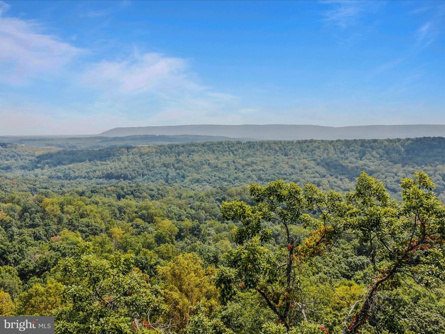 Spectacular lot in the Coolfont Mountainside Association (CMA).  The lot sits at the end of the cul-de-sac and looks mostly east with wide angle views into three states.  The lot also backs onto Cacapon State Park land.  Enjoy sunrises to the front and no homes in view below.  Custom design your home on the 1.12 acres. Amenities in the community are an outdoor pool, hot tub, tennis courts, basketball court, playground, and hiking trails.  The lots in the community feature electric, water, and sewer lines. Every lot installs double septic tanks when they build, there is no need for a septic field so no need for a perc test, as it is managed through the CMA sewer line system and the owner simply pumps the tank as needed. The view possibilities are tremendous at this property. 

Berkeley Springs is a short drive where you’ll find another state park,  restaurants, and the benefits of being in an small artistic community awaits you. Ten minutes from this lot is the Robert Trent Jones, Sr.- designed 18 hole golf course at Cacapon State Park, offering spectacular views. This lot is the best of both worlds, close to town and living in the splendor of nature also.