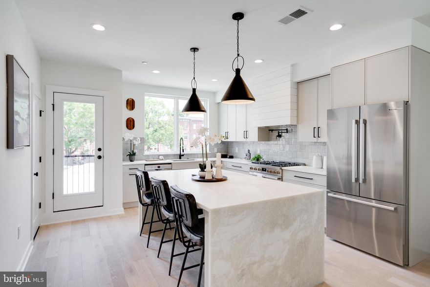 Introducing, Wendle Place! This 34 townhome community is brought to life by the premiere, Catalyst City Development, designed by the renown Gnome Architects and built by the highly talented GRIT Construction. With 4 development phases in total, Wendle Place will span from N 6th Street to N Marshall Street featuring an exclusive community drive aisle and a private park to enjoy the outdoors. The N 6th Street facing homes will be the final properties delivered in the development. Located in the heart of Northern Liberties, one of Philadelphias most desirable and dynamic neighborhoods, Wendle Place will bring a refined way of living to the city, exhibiting classic architecture combined with modern living features. Each townhome is 19ft wide, nearly 3,000 sq ft of living space and includes above standard ceiling heights throughout living spaces. These homes boast 3 bedrooms, 3 full and 2 half bathrooms, 2 car garage parking, multiple outdoor spaces and a private rooftop with green roof, along with 2 distinguished design packages and a la carte upgrades to ensure you are customizing your dream home.  This specific unit features a handful of upgrades including Waterfall Countertops in the kitchen, Coffered Ceilings, upgraded laundry room and a living room gas fireplace. Included with each home is a full 10 Year Tax Abatement and 1 Year Builders Warranty. The main living space is an open concept double-height floor plan with 13.5 foot ceilings. Overlooking the main living space is the kitchen and dining area. This stunning chef's kitchen features a Bosch Stainless Steel Appliance Package, contemporary finishes, with an adjacent dining area and tons of natural light from the large Pella windows throughout. The dining area also features a private deck off of the kitchen that is perfect for entertaining guests, grilling or relaxing. The second level is home to 2 bedrooms with 2 full bathrooms, one en-suite with a stand-in shower, the other off of your hallway with a soaking depth tub, and a laundry room large enough for a side-by-side washer & dryer. Up the stairs to the third level is the primary en-suite. The primary en-suite features a spacious, light-filled bedroom with a Juliet balcony, oversized walk-in closet with built-in shelving, and a spa-like bathroom with soaking tub and a large dual rain head stand-in shower with a built-in bench. This floor also features a wet bar (with options to upgrade and customize), right off of the entrance to the private rooftop deck with unobstructed city-wide views. This private rooftop comes fully equipped with a green roof, offering an environmentally conscious approach to city living. The green roof system dampers daytime temperatures and regulates cooling at night. Finally, the finished lower level basement space is perfect for your next home office, private gym, or additional entertainment space, with access to the 2-car garage. Wendle Place is in close proximity to all of Northern Liberties fan favorite bars, restaurants, cafes and shops including Bardot Cafe, Cafe La Maude, and North Third to name just a few. Easy access to Liberties Walk pedestrian mall, bike paths and tons of charming boutiques. Center City is a short distance from Northern Liberties and public transportation is right around the corner offering a variety of ways to get around. You do not want to miss out on this refined way of living, contact our office today to schedule a walkthrough! Units in Phase 1 are ready to be delivered.