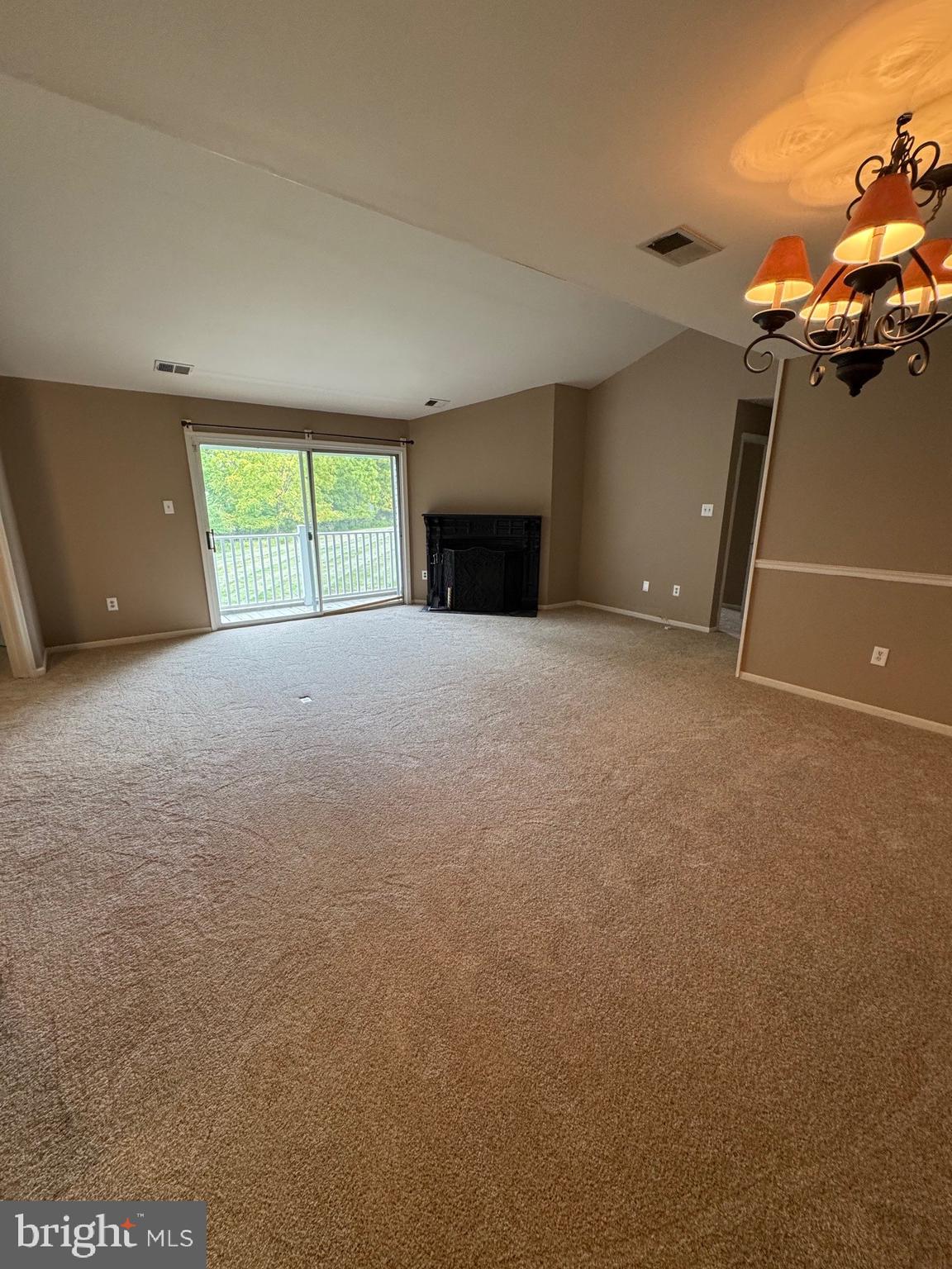 Step into this bright and inviting 2nd-floor condo featuring 3 bedrooms and 2 full baths, all enhanced with brand-new carpets throughout. The spacious living room boasts soaring vaulted ceilings, a cozy fireplace, and abundant natural light. The primary suite offers a private retreat with two closets and its own full bathroom, while the second bedroom includes a walk-in closet. Enjoy the convenience of an in-unit laundry room and relax on your private balcony with additional storage. Tucked away in a quiet setting, this move-in ready home combines comfort, style, and convenience in one perfect package—close to shopping, restaurants, and major routes.