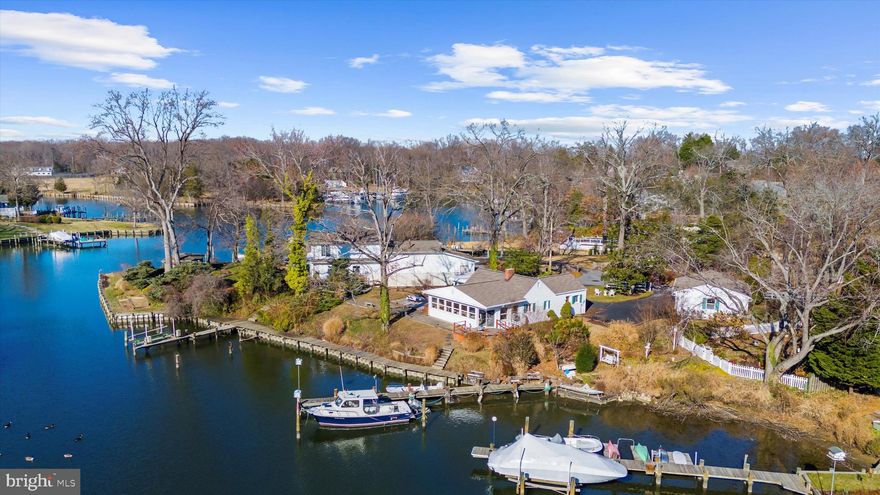 Serene cottage with pier, perfect for coastal living.  Located on a private waterfront pensinsula,  enjoy one level living with massive waterviews.  A paved circular driveway welcomes you to the property, highlighted by a beautiful magnolia tree at its center. Featuring  a charming galley kitchen, 2 spacious bedrooms (virtually staged), 2 full baths, and an open living room with a pellet stove that flows into the dining area and family room.  A deck off the living space provides an inviting outdoor dining area while the large rear yard offers multiple spaces, including a hot tub, for enjoyment and relaxation.  A charming waterfront walkway, supported by a durable composite bulkhead, leads to a private pier with a boat lift already installed—perfect for easy boating and direct water access. The expansive 3 car detached garage provides excellent versatility for storage, workshop use, or future customization. The fenced side yard behind the garage offers additional outdoor space suitable for pets, gardening, or recreation. A strong opportunity to update and personalize  your dream home. Home is sold as-is. Buyer to verify water depths (estimated at 4FT MLW), permitted uses, and any desired improvements.

Loch Haven offers an impressive range of waterfront and recreational amenities for residents and their guests. The community features a sandy beach with chairs and picnic tables, a pier with boat slips, a scenic overlook on the river, and a ball field used for neighborhood events. A recreation area includes a tennis court, basketball court, playground, and additional picnic spaces