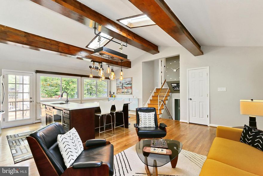 Open House 11-1 Saturday 4/26 and 12-2 Sunday 4/27.  Total square footage is 2160. Not your typical split level! Over $50K of improvements in the past 2 years! This unique 4-level home has a completely open main level and features a brick and plaster wall as a focal point.  The gorgeous kitchen has solid wood cabinets, all stainless appliances, including a French door refrigerator, built-in microwave, and wall-mounted range hood. Textured quartz counters wrap around to create a spacious breakfast bar with seating for 2, along with extra counter space. The dining area boasts a built-in bench and a wall of narrow cabinets where you can display all of your favorite photos. The cathedral ceilings are highlighted by dramatic wood beams. Side windows that follow the roof line, 2 large skylights, along with a wall of windows, brighten the room during the day, while gorgeous pendant lighting and concealed up-lighting does the job at night. Up a half flight of stairs and you’ll find 3 spacious bedrooms, all with generous and increased closet space. There is also a completely remodeled and enlarged bath featuring 2 large vanities, brick walls with embedded mirrors, a beautiful ceramic tile tub and separate shower. Another skylight lets the sun stream into the bathroom. The family room level has a wood mantel that spans the brick wall, and a fireplace with a wood stove insert. The built-in corner cabinet and closet add extra storage. This level also includes a spacious 4th bedroom with side entrance, and another spa-like enlarged bath with ceramic tile shower and a wood accent wall. All 3 levels boast gleaming hardwood floors. The bonus lower level 2 is an open room with ceramic tile floors. The kitchenette has an abundance of white cabinets, a 2nd refrigerator and a 2nd dishwasher. Walk-up stairs lead to the back yard, and there is also an egress window. A nice large storage closet, utility room and laundry closet complete this level. This home has all double-paned, energy-efficient windows. A brand-new roof, including all new sheathing, with a 25-year warranty, along with new skylights and B-vent were all installed in March 2025. New HVAC, condensation pump, basement exchange vent (2023). New 200-amp panel with whole home surge protector (2023). Fresh paint and refinished hardwoods (2023). Many more recent improvements. Water heater 2014. The large corner lot has a fully fenced back yard that is ready to host a party! Meander around the various patios and decks; some trellis covered and one with a stainless, hooded brick Bar-B-Q. There is also a large storage shed. Located minutes from the paved “Accotink Stream Valley” portion of the 40-mile-long Cross-County Trail leading to Lake Accotink just over a mile away. Super, close-in location close to almost every major commuter route and minutes from the Franconia/Springfield blue line Metro as well as the Rolling Road or Springfield Virginia Railway Express. 13 miles to the Pentagon, 8 miles from Fort Belvoir and 4 miles from the National Geospatial-Intelligence Agency. An abundance of shopping choices including the Springfield Town Center, Whole Foods, Trader Joe’s, and a gourmet Giant. All in the top-rated Keene Mill ES, Irving MS and West Springfield HS pyramid (Elementary and High Schools have recently been completely renovated). You will love living here!