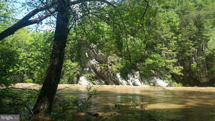 One of the most scenic areas of the Cacapon River, totally private setting with over 1,000 feet of river frontage, electric to the property and septic permit. Several building sites could overlook the river and be outside of flood zone. Beautiful ferns and rock formations abound. Truly a spactacular property for an exceptional price, Call Today.