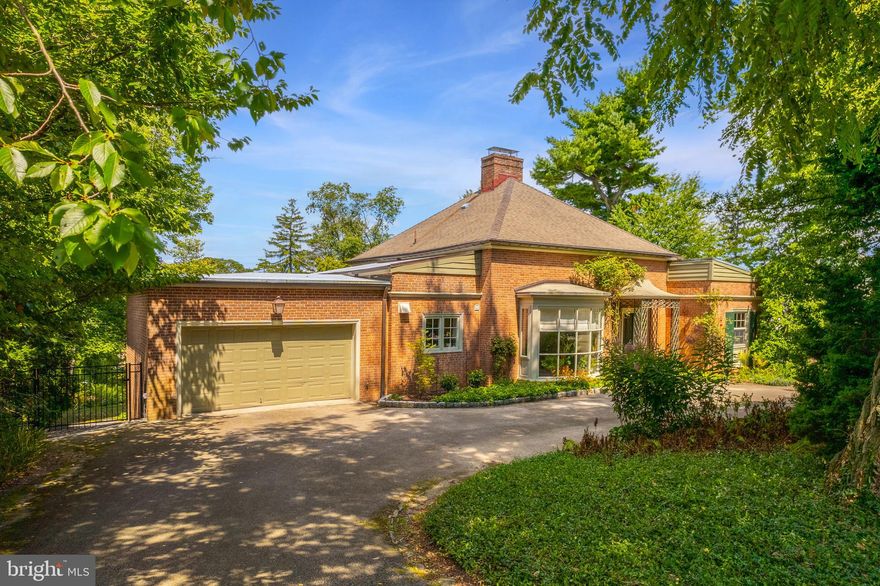 Mid-century vibes meet gorgeous garden oasis in this immaculate 4 bedroom, 4 bath home on 0.66 acres in a fantastic location in Chestnut Hill. Built in 1957 and expanded upon, this sunlit home features walls of windows showcasing a fabulous, terraced backyard filled with perennial plantings, flowers and mature trees. The original iron portico leads to the entrance foyer, giving a glimpse into the open, functional floor plan with gorgeous inlaid herringbone floors and crown molding. To the left is the dining room, sunlit by a large solarium window. Enter the expansive living room with wood-burning fireplace and wall of sliders to the deck that looks out onto the rear gardens. The kitchen offers terracotta floors, open shelving, Sub-Zero, Miele and Bosch appliances, breakfast area, access to the 2-car garage and double glass doors lead to the rear elevated deck. The right-hand wing of the home offers a paneled study with built-ins, full hall bath, spacious bedroom with closet, and the primary bedroom suite, with dual full bathrooms with dressing areas and closets, and large primary bedroom overlooking the beautiful rear grounds. The walkout lower level offers an expansive family room with fireplace and French doors to the rear slate patio, a full hall bath, 2 large bedrooms, the laundry, and the utility area. The walk-up upper level of this gorgeous home offers a huge area that can be finished off for extra living space or bedrooms, or kept as storage space. The grounds of this property are truly special – relax in your very own sanctuary listening to birdsong, looking out over terraced gardens and trees. The owners added an additional parcel of land to the property to bring it to 0.66 acres. All this and more, in a location just a short hop to the shops and dining along Germantown Ave, easy access to the Lavender Trailhead of Fairmount Park, the train station and major roads.