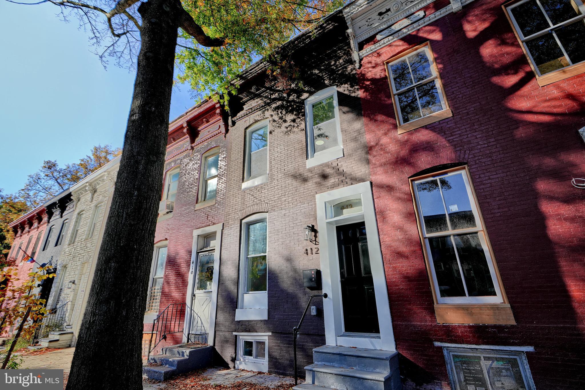 Welcome to this charming newly renovated 2 bed, 2.5 bath brick row home in the vibrant Greenmount West neighborhood, just a short stroll from Penn Station, bus routes, and local shopping and dining. This residence features an inviting open-plan main level with a gourmet kitchen equipped with quartz countertops and stainless steel appliances that flows into the living room, perfect for entertaining. Upstairs, you'll find two generously sized bedrooms, each with its own adjoining en suite bathroom, ideal for families or roommates seeking privacy. A convenient half bath on the main level is perfect for guests, while the rear wood privacy-fenced yard provides the perfect opportunity for relaxation and gatherings. The functional basement offers laundry hookups and excellent storage options. Could also be a den or office. With a brand new roof, HVAC system and hot water heater, this home combines modern comfort with urban convenience.