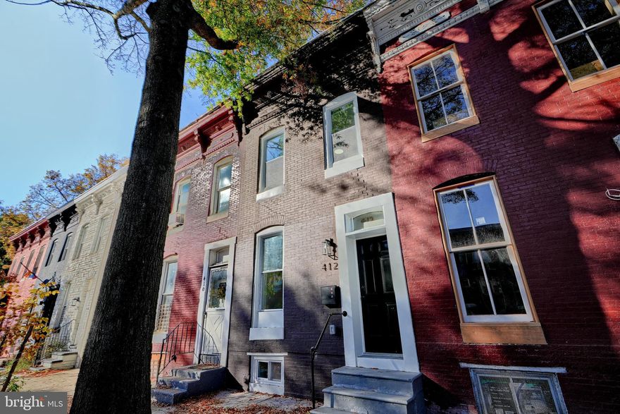Welcome to this charming newly renovated 2 bed, 2.5 bath brick row home in the vibrant Greenmount West neighborhood, just a short stroll from Penn Station, bus routes, and local shopping and dining. This residence features an inviting open-plan main level with a gourmet kitchen equipped with quartz countertops and stainless steel appliances that flows into the living room, perfect for entertaining. Upstairs, you'll find two generously sized bedrooms, each with its own adjoining en suite bathroom, ideal for families or roommates seeking privacy. A convenient half bath on the main level is perfect for guests, while the rear wood privacy-fenced yard provides the perfect opportunity for relaxation and gatherings. The functional basement offers laundry hookups and excellent storage options. Could also be a den or office. With a brand new roof, HVAC system and hot water heater, this home combines modern comfort with urban convenience.