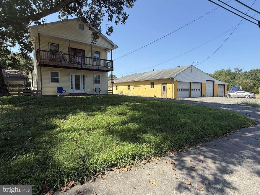 Valuable C2 commercial zoning allows for many uses including car sales, car repair, construction yard, and more. 4.78 acres improved by a 2,031sf house and approximate 4k sf garage. 7 bay garage has four roll up doors: two 12'x8', one 10'x8', and one 8'x8'. One of the 12'x8' bays has car lift and pit. House has 3 bedrooms and 2 full baths. Situated 14 miles east of Fredericksburg in King George County, VA, off Rt 3 and Rt 301. Near Sheetz, Tractor Supply, Food Lion, YMCA, King George County High School, Government offices, Truist, Atlantic Union Bank, and more. Proof of funds required for showing. Serious inquires only.