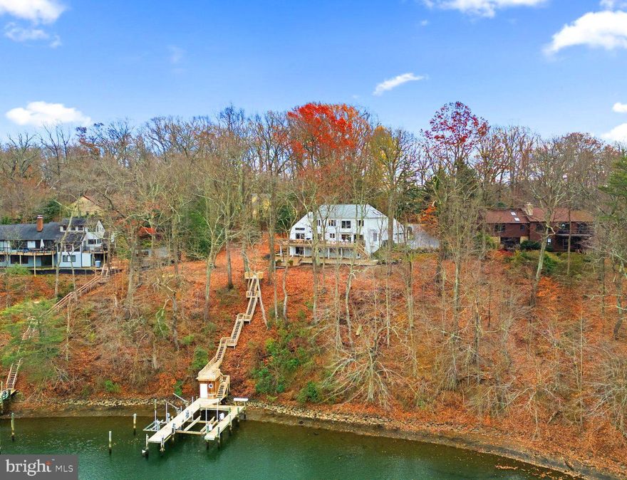 WATERFRONT TRIFECTA!!!!!! The three MAJOR factors of a waterfront property: superior waterfrontage on a private lot, an established community with amenities, and an updated home.  

SUPERIOR WATERFRONTAGE:  This 1.11 acre property has an astounding MLW of 14 feet, 200 feet of waterfrontage, multi vessel pier equipped with two boat lifts (25,000lb and 2,800lb) and four slips. Keep your seaworthy vessel tucked into the highly coveted “Hurricane Hole” of Brewer’s Creek  which is seconds from the Severn River.  This incredible location is totally protected from the chop and wind of being directly on the river.  From this dock you could go anywhere in the world! Swimming Pool feasibility completed and available upon request.

ESTABLISHED COMMUNITY:  The Downs on the Severn is an iconic Annapolis water privileged community.  Prior to the community being built it was a golf course and the easy rolling hills and wide streets make this the best walking community in all of Annapolis.  The Downs offers a community pool, tennis courts, pickle ball courts, a clubhouse with planned social events, and playground. The community just completed an extensive update to Clements Creek Marina with floating docks! This marina offers 76 boat slips for Downs home owners. There is also a second, smaller marina on Brewers Creek that offers a ramp for the smaller/trailered vessels. The location of the home and community is perfection with easy access to route 50 and route 97.  Within one hour of two major airports (BWI and Reagan) but the small city vibe of Annapolis.  

UPDATED HOME:  This Coastal Contemporary waterfront home has been meticulously maintained with high end finishes throughout. The custom home boasts over 4,000 finished square feet across 3 living levels.  Entertaining space abounds on multiple levels both indoor and outdoor.  4 spacious bedrooms with 3 full and 1 half bathrooms, a gourmet inspired kitchen with granite counters, integrated Sub Zero refrigeration, Wolf Cooking dual sinks all overlooking expansive decks with amazing water views. Walls of glass highlight water views from nearly every room while the soaring high ceilings and neutral color palette offer bright and sun filled rooms. Newly finished hardwoods and gorgeous tiled floors shine throughout. Waterside formal living and dining rooms flow seamlessly together while maximizing view of Brewer's Creek. The primary suite is the ultimate place for relaxation with a private en suite bathroom with designer inspired finishes including marble counters and tiled shower with dual sink vanity. Step out onto the private balcony overlooking your wooded waterfront retreat. Two additional bedrooms, both with soaring ceilings accented by kid’s lofts, and a full hall bathroom complete the upper level. The walk out lower level where you'll find easy access to your full length covered patio with huge views. A game room complete with wet bar ensures you can entertain all year long, never tiring of the ever changing views. The lower level is complete with a full bathroom and fourth bedroom, making it a perfect guest, in-law or au pair suite. Full list of updates in the disclosures which are sure to satisfy the most scrupulous of buyers.