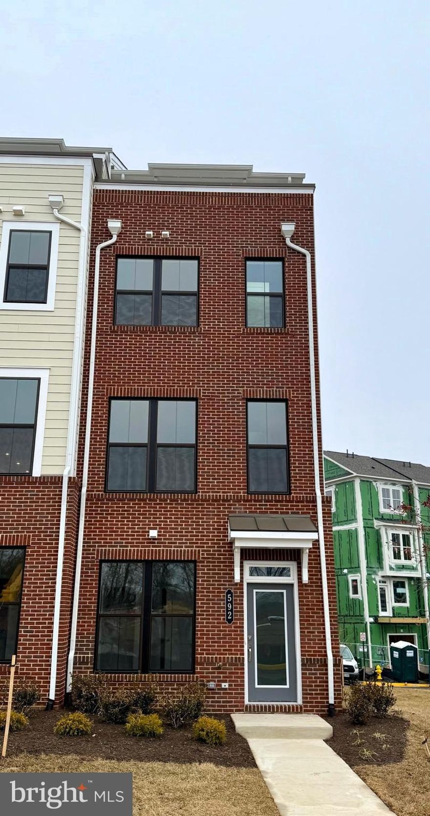 NEW MILLER AND SMITH HOME IN BEACON PARK AT BELMONT BAY READY FOR QUICK MOVE-IN! Gorgeous 4 level, 4 bedroom 4.5 bath end-unit townhome with rooftop terrace. Full brick front, 1st level includes 3rd bedroom with private full bath with shower, and single car rear load garage plus driveway parking. Main level kitchen with center island, balcony, dining room and spacious great room. The 3rd level boasts a primary suite with 2 walk in closets, rear bay window, tray ceiling, luxury bath, laundry room, and 2nd bedroom with private full bath. The 4th level includes a large finished loft, 4th bedroom with private bath, and open terrace. Hardwood staircases throughout,  crown molding in primary suite, dining and great room, upgraded kitchen and bathroom cabinets,  upgraded granite countertops in kitchen, luxury vinyl plank flooring throughout, luxury tile backsplash in kitchen, upgraded  tile in all baths. $134,300 in upgrades! Don't miss this one!!