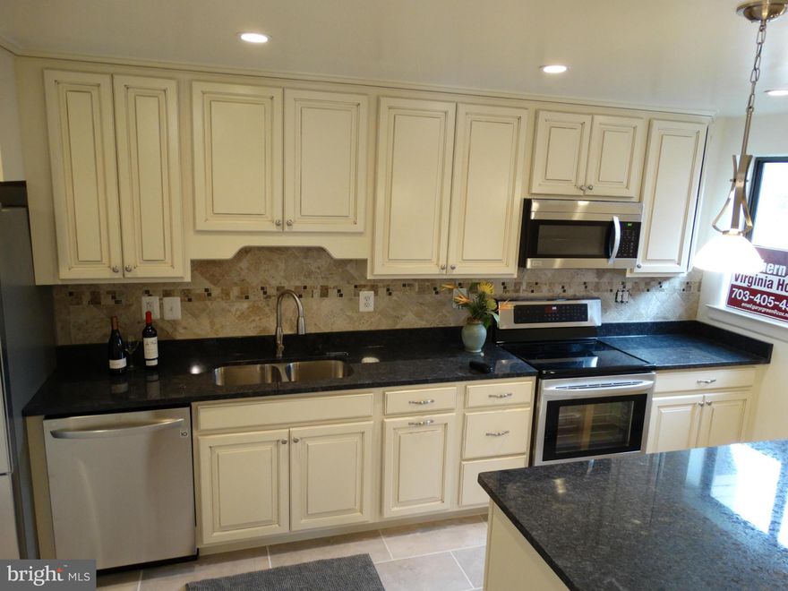 Lake Front Living on Lake Thoreau with Garage*Totally Renovated 2 Br 2.5 BA 2 Level 1520 Sq Feet*Two Large Patio/Balconies Overlooking Lake Thoreau*New Kitchen w/ SS Appliances, New Granite, New Cabinets and Floors*New Hardwoods on Upper and Lower Levels and Bedrooms*New Bathrooms*New Windows on Order*LR Fireplace*Close to Reston Amenities, Town Center, Shopping and Silver Line Metro*