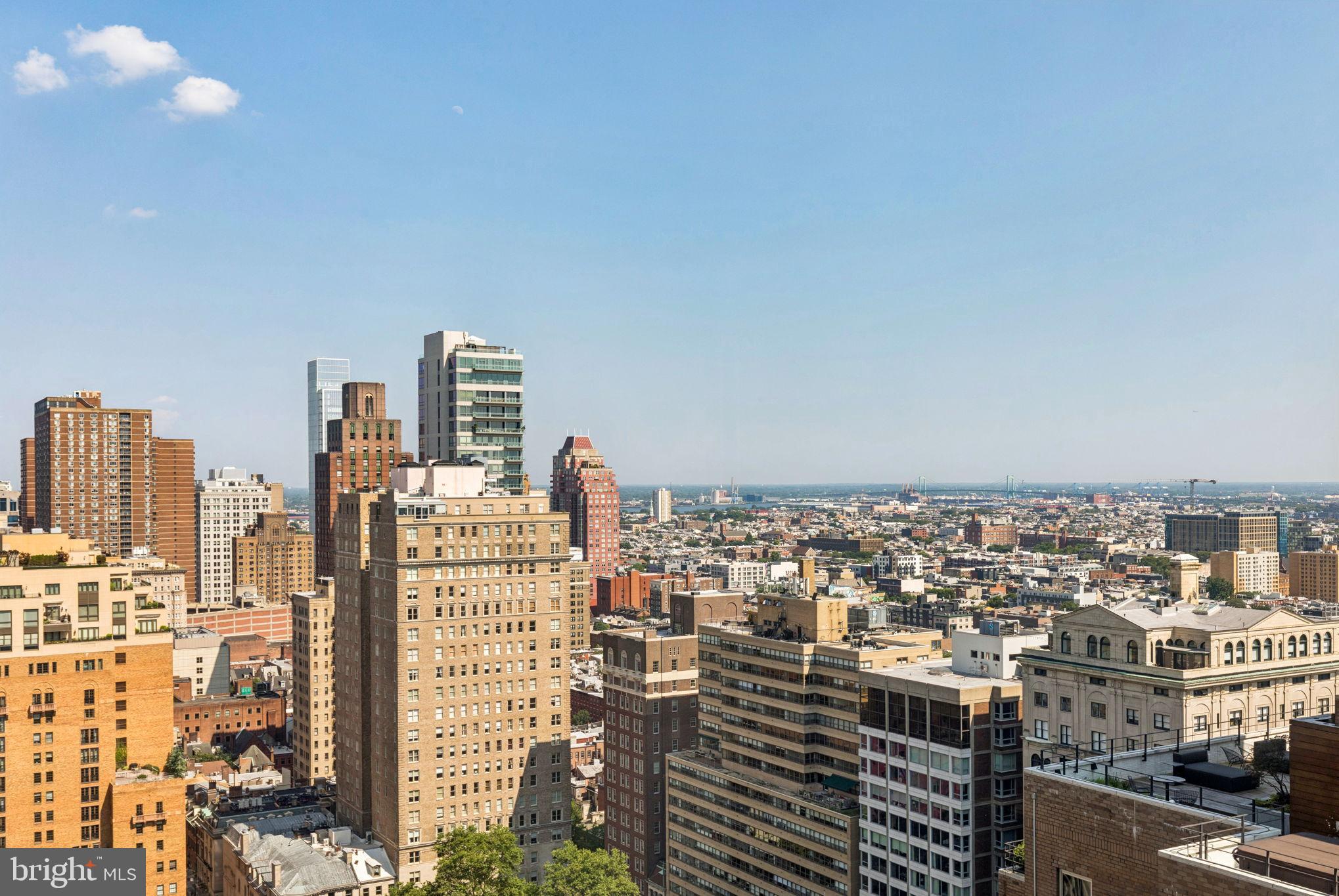 Beautifully maintained two bedroom, two and a half bathroom with Rittenhouse Square views from every room on a high floor of the highly coveted Residences at The Rittenhouse Hotel. This home boasts some of the most incredible views in the city, spanning from Rittenhouse Square and Center City all the way to the Delaware River. Enter through a grand foyer with excellent wall space for artwork and a conveniently located powder room which features a single black vanity with ornate vessel sink and a black TOTO toilet. The foyer leads to an expansive great room with ample space for living and dining and two walls of oversized windows offering excellent natural light and breathtaking city views. Adjacent to the great room is a large kitchen with ample cabinetry, granite countertops, beautiful diamond shaped tile backsplash, breakfast bar overlooking the dining room, tile floor, and high end stainless steel appliances including a Sub-Zero fridge, Miele dishwasher, and Dacor microwave, oven, and range. Off of the kitchen is a laundry room with side by side washer/dryer and excellent storage space. The spacious primary suite features more massive windows, a large walk-in closet with built-ins, and a marble-appointed ensuite bathroom with double vanity, glass walk-in shower, and deep jacuzzi tub. The second bedroom is generously sized and enjoys more oversized windows, hardwood floors, and a marble-appointed ensuite bathroom with large single vanity and glass enclosed tub shower. Additional highlights include arched entryways, exquisite crown and baseboard molding, beautifully milled doors, light washed engineered wood floors, recessed lighting, and incredible closet space throughout. The condominiums at The Rittenhouse sit atop the five-diamond Rittenhouse Hotel. Residents of The Rittenhouse enjoy the use of a chauffeur-driven town car, concierge, and 24-hour lobby attendant. And for an additional fee they can enjoy the same amenities as hotel guests, including valet parking, housekeeping services, room service, spa and fitness center, indoor pool, dog walking, the newly renovated Paul Labrecque Salon, and Lacroix Restaurant.