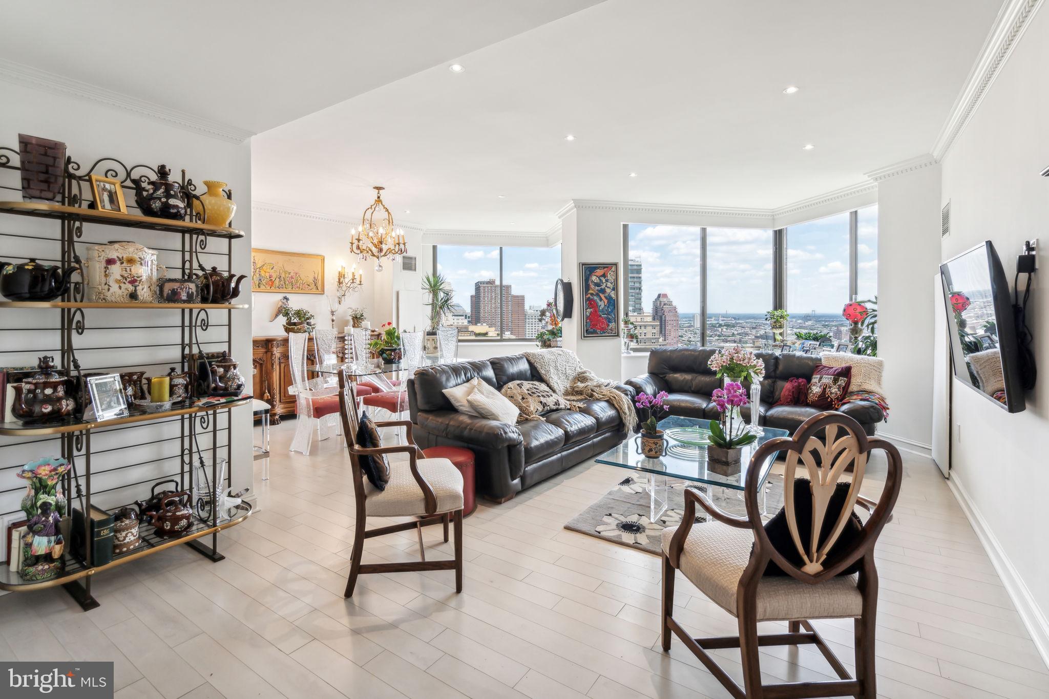 Beautifully maintained two bedroom, two and a half bathroom with Rittenhouse Square views from every room on a high floor of the highly coveted Residences at The Rittenhouse Hotel. This home boasts some of the most incredible views in the city, spanning from Rittenhouse Square and Center City all the way to the Delaware River. Enter through a grand foyer with excellent wall space for artwork and a conveniently located powder room which features a single black vanity with ornate vessel sink and a black TOTO toilet. The foyer leads to an expansive great room with ample space for living and dining and two walls of oversized windows offering excellent natural light and breathtaking city views. Adjacent to the great room is a large kitchen with ample cabinetry, granite countertops, beautiful diamond shaped tile backsplash, breakfast bar overlooking the dining room, tile floor, and high end stainless steel appliances including a Sub-Zero fridge, Miele dishwasher, and Dacor microwave, oven, and range. Off of the kitchen is a laundry room with side by side washer/dryer and excellent storage space. The spacious primary suite features more massive windows, a large walk-in closet with built-ins, and a marble-appointed ensuite bathroom with double vanity, glass walk-in shower, and deep jacuzzi tub. The second bedroom is generously sized and enjoys more oversized windows, hardwood floors, and a marble-appointed ensuite bathroom with large single vanity and glass enclosed tub shower. Additional highlights include arched entryways, exquisite crown and baseboard molding, beautifully milled doors, light washed engineered wood floors, recessed lighting, and incredible closet space throughout. The condominiums at The Rittenhouse sit atop the five-diamond Rittenhouse Hotel. Residents of The Rittenhouse enjoy the use of a chauffeur-driven town car, concierge, and 24-hour lobby attendant. And for an additional fee they can enjoy the same amenities as hotel guests, including valet parking, housekeeping services, room service, spa and fitness center, indoor pool, dog walking, the newly renovated Paul Labrecque Salon, and Lacroix Restaurant.