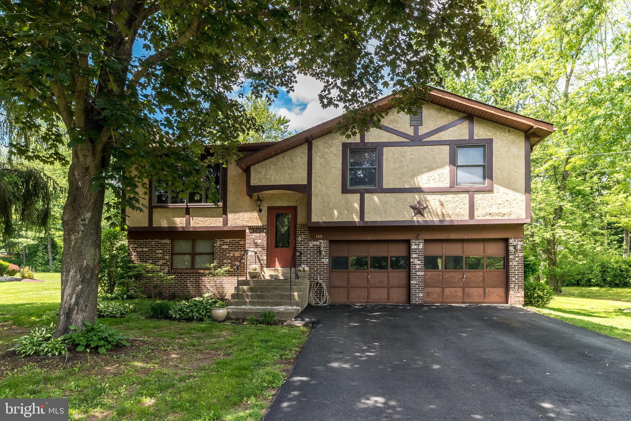 This spacious bi-level 3-bedroom, 1.5-bath home sits on a peaceful ½-acre lot in a fantastic location close to everything. Tucked away on a quiet street, it features an oversized two-car garage, a large private backyard, and plenty of potential to make it your own. The kitchen offers direct access to a screened-in deck through sliding doors—perfect for indoor-outdoor living. Inside, you’ll find two charming brick fireplaces, one with propane insert in the cozy living room and another in the huge lower-level family room, which also features sliders leading to a patio. With public sewer service, this home just needs a little love to truly shine!